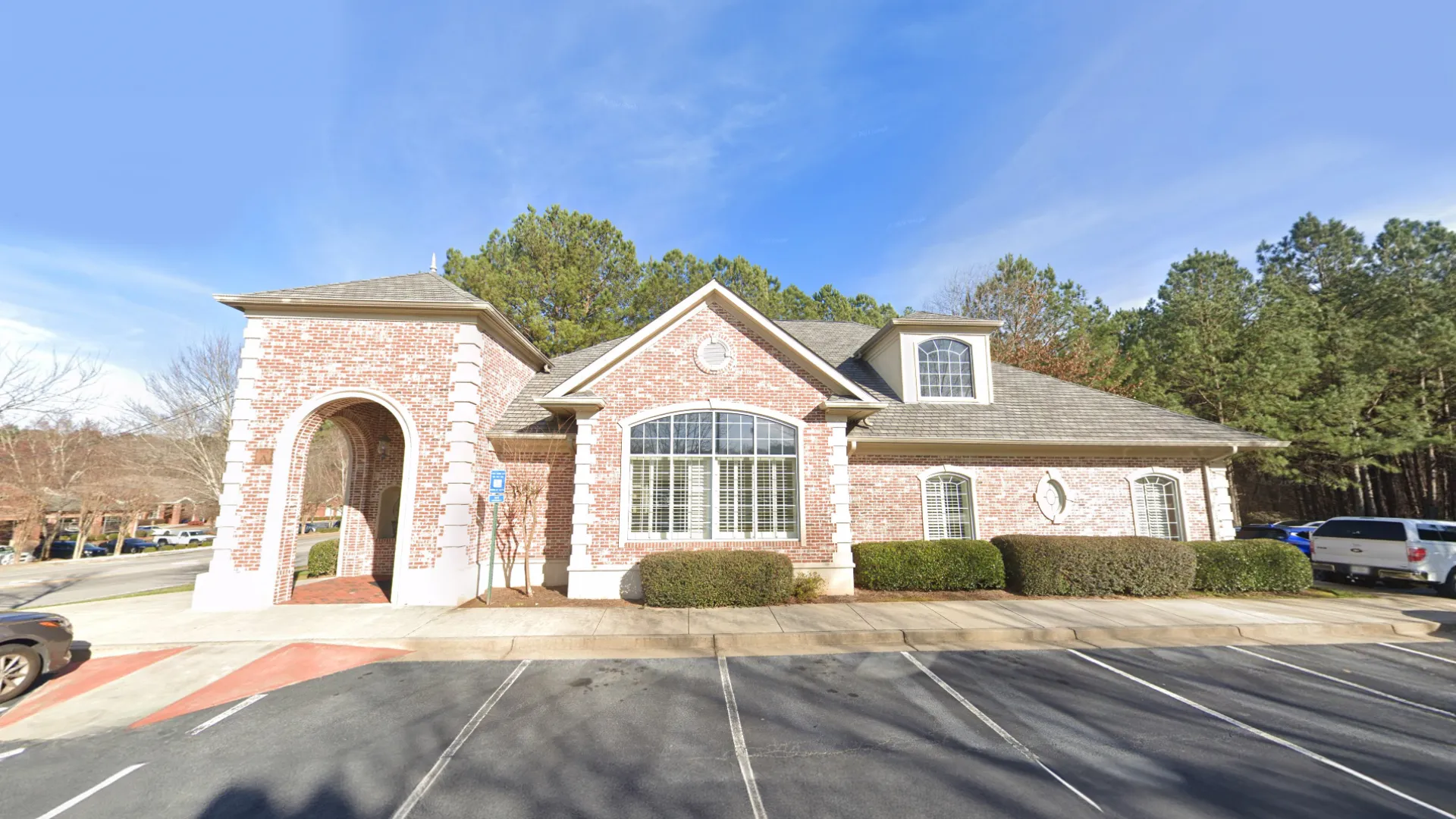 a brick building with a parking lot