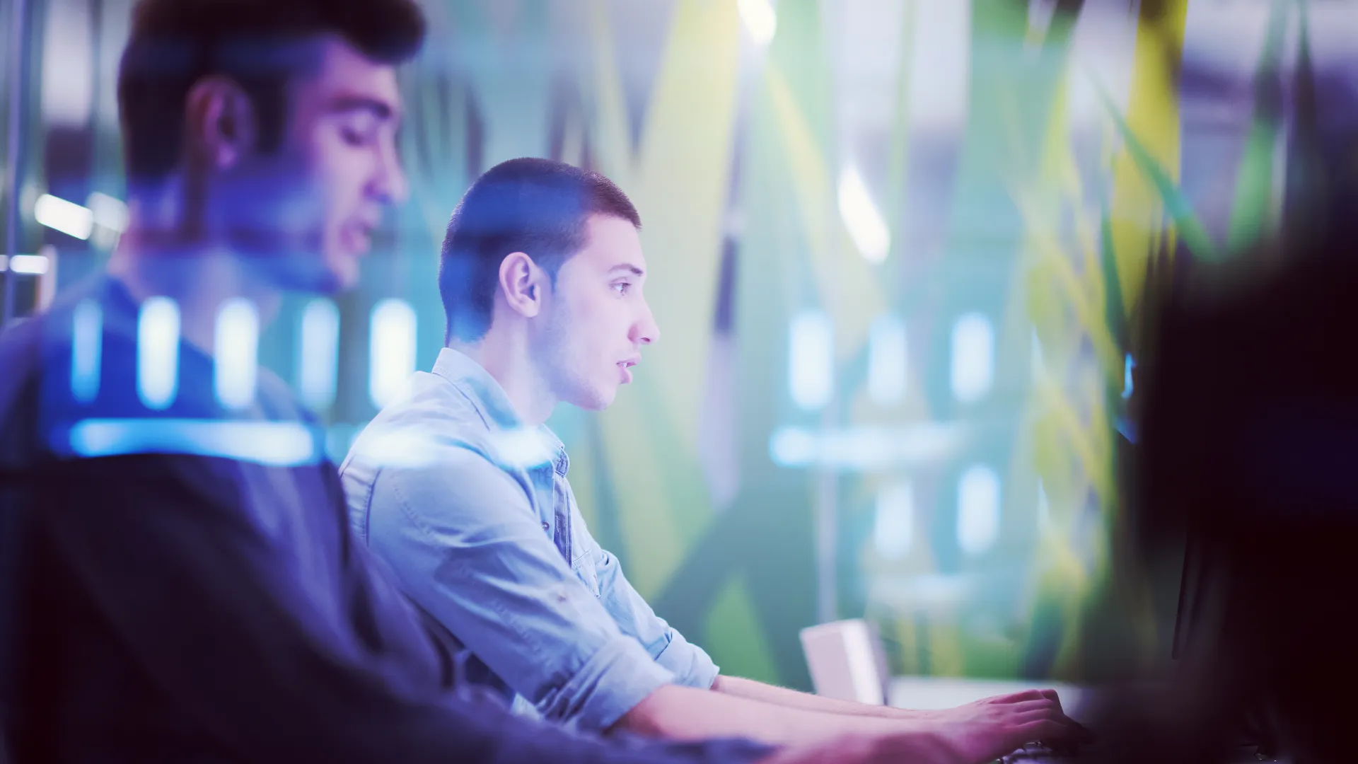 a man and a woman looking at a computer screen