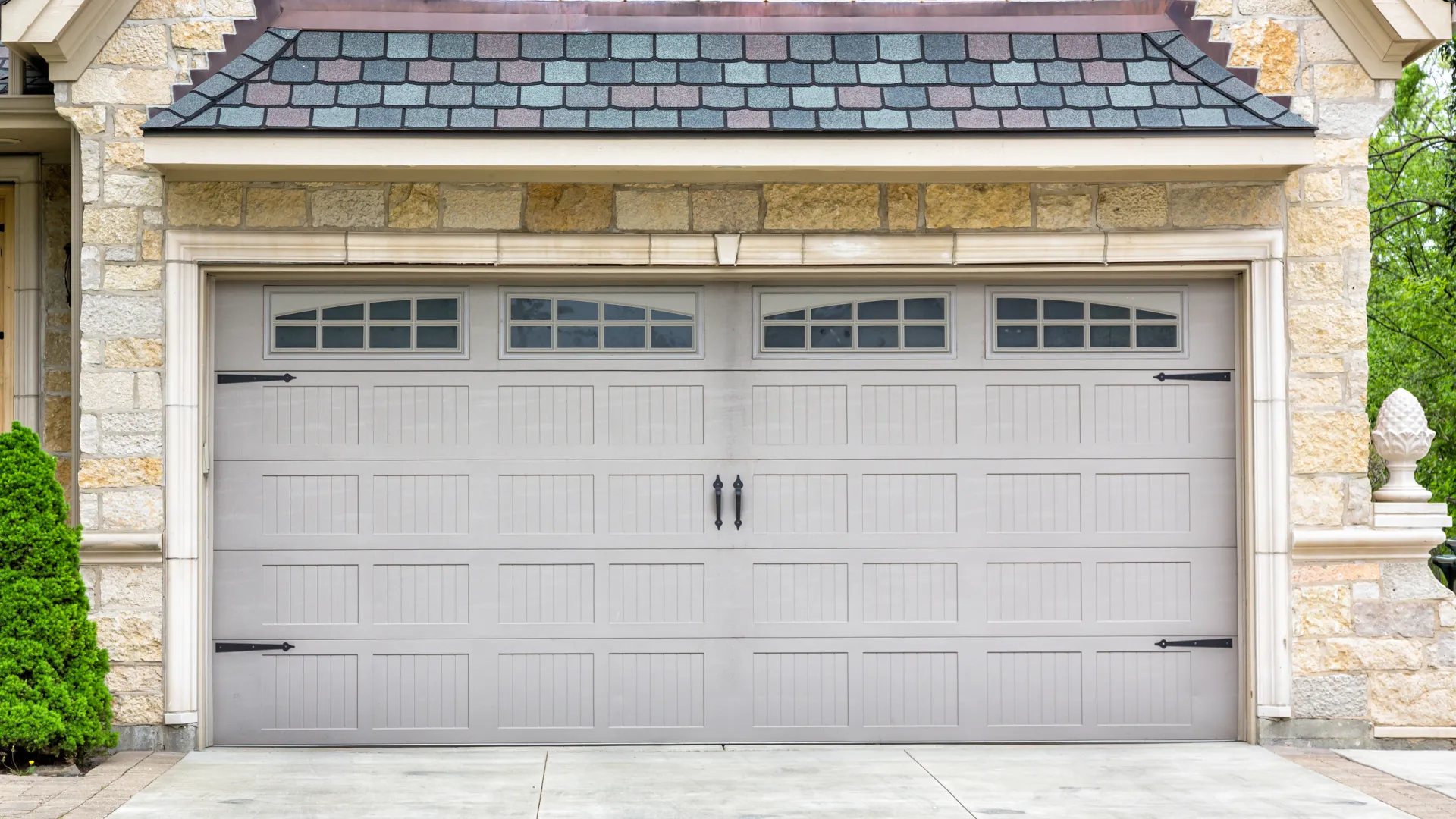 a garage door with a brick building in the background