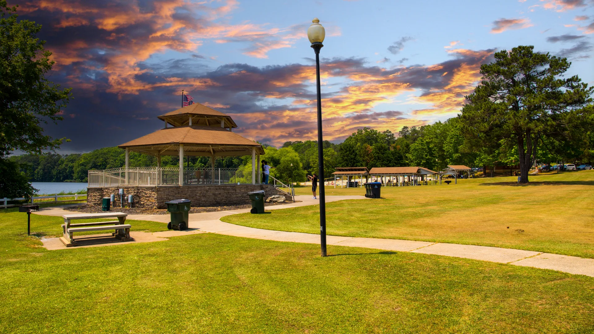 a park with a lamp post and a gazebo