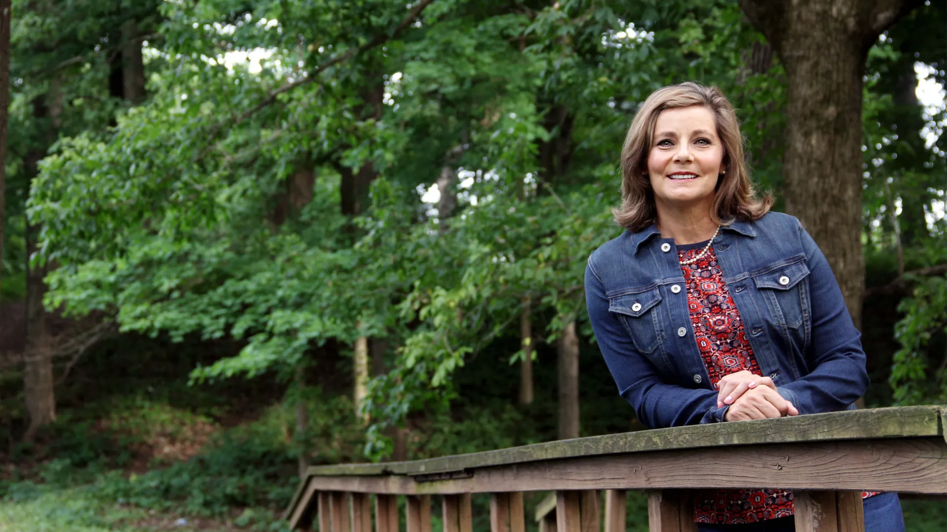 a person sitting on a bench in a park