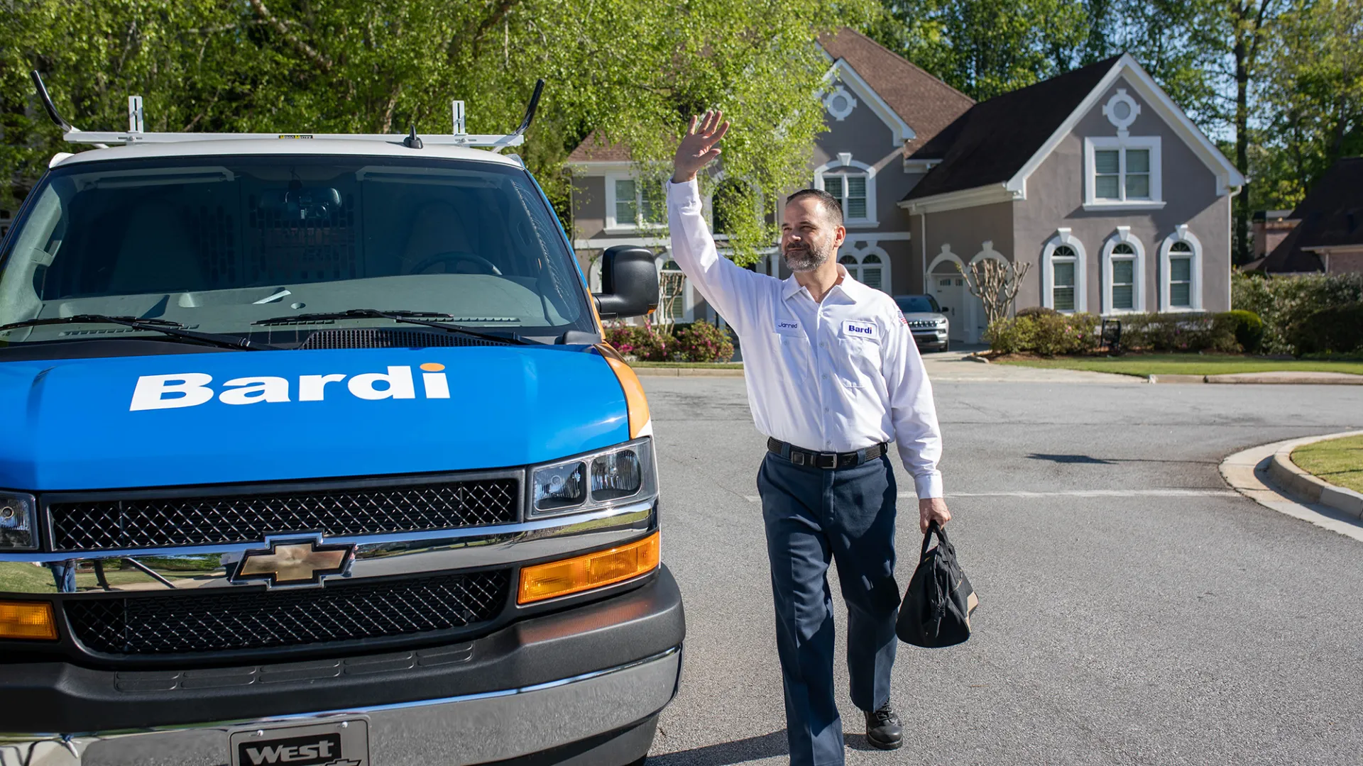 a man waving at a truck