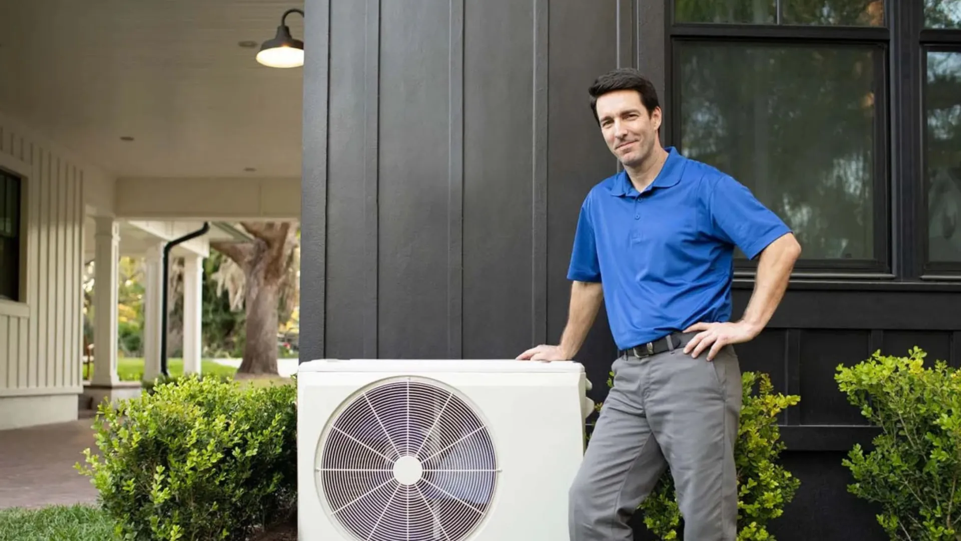 a man standing next to a fan