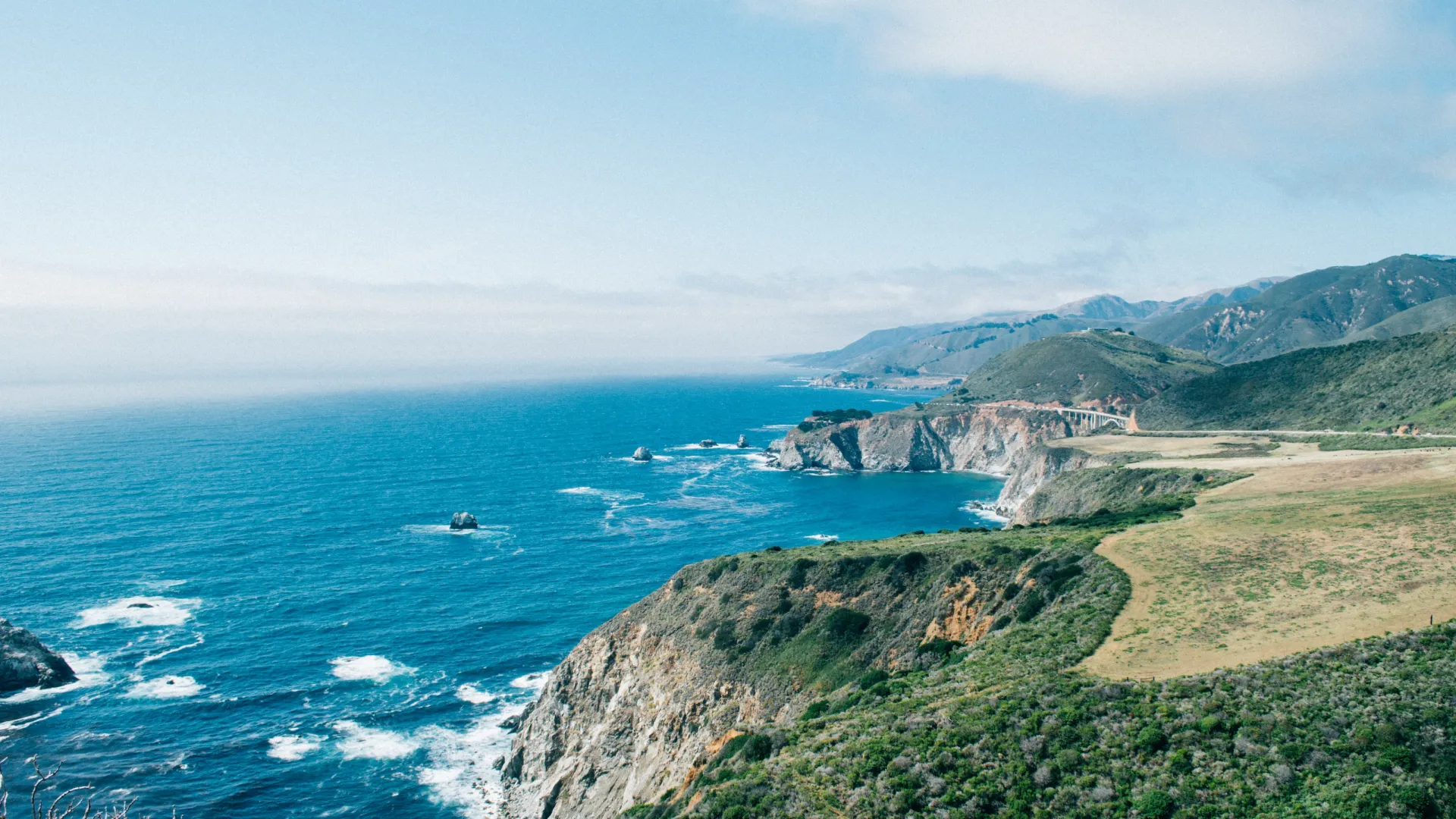 a body of water with land and hills around it