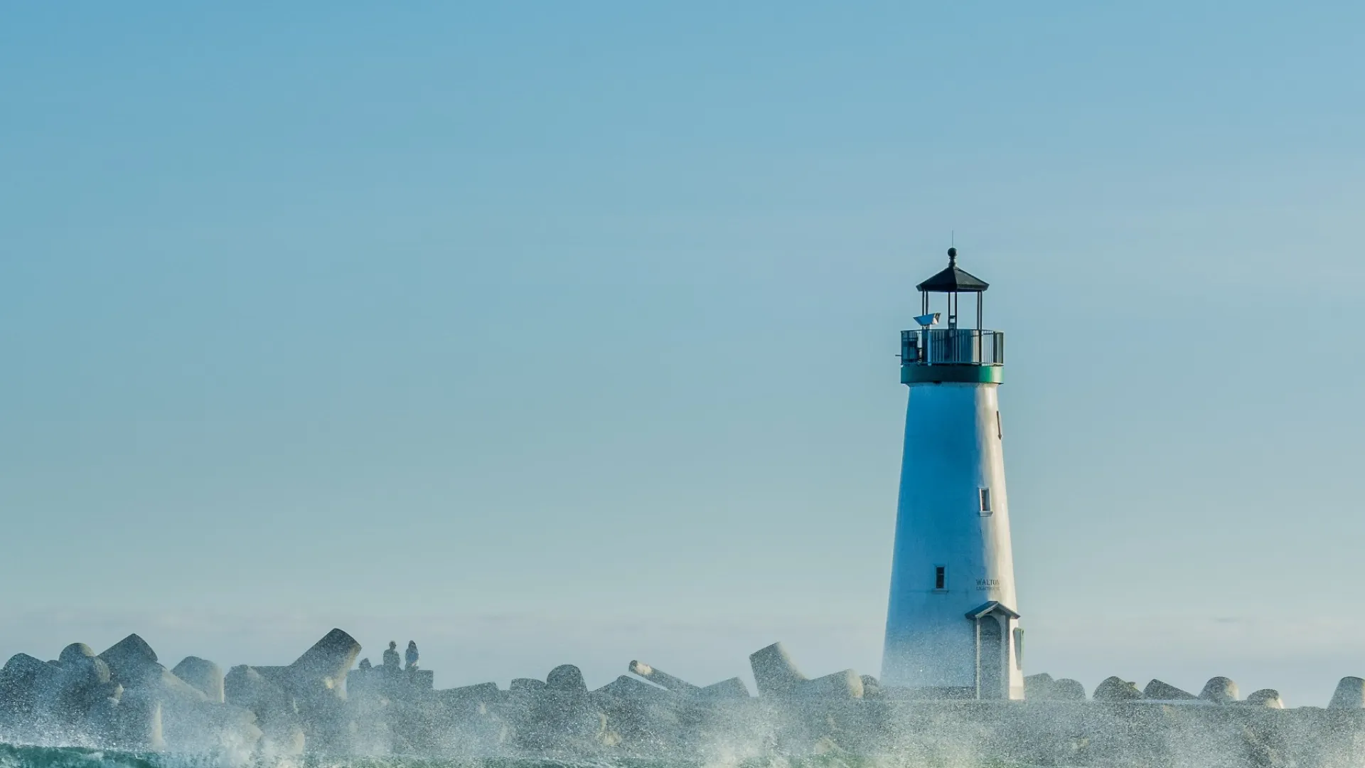 a lighthouse on a wave