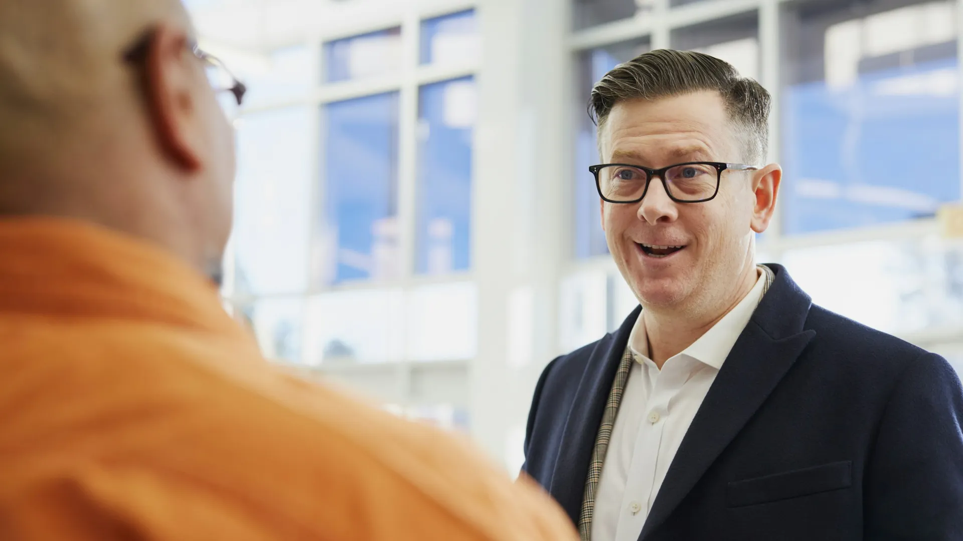 a man in a suit talking to a man in a suit