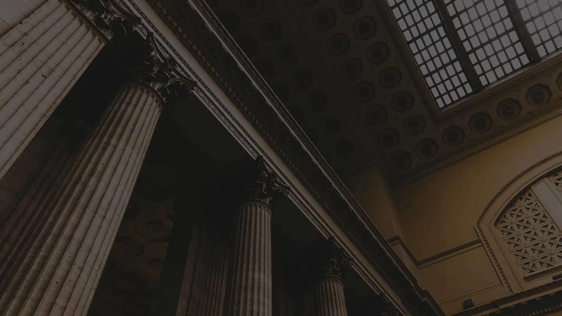 Interior view of classical building with large Corinthian columns and skylight ceiling window