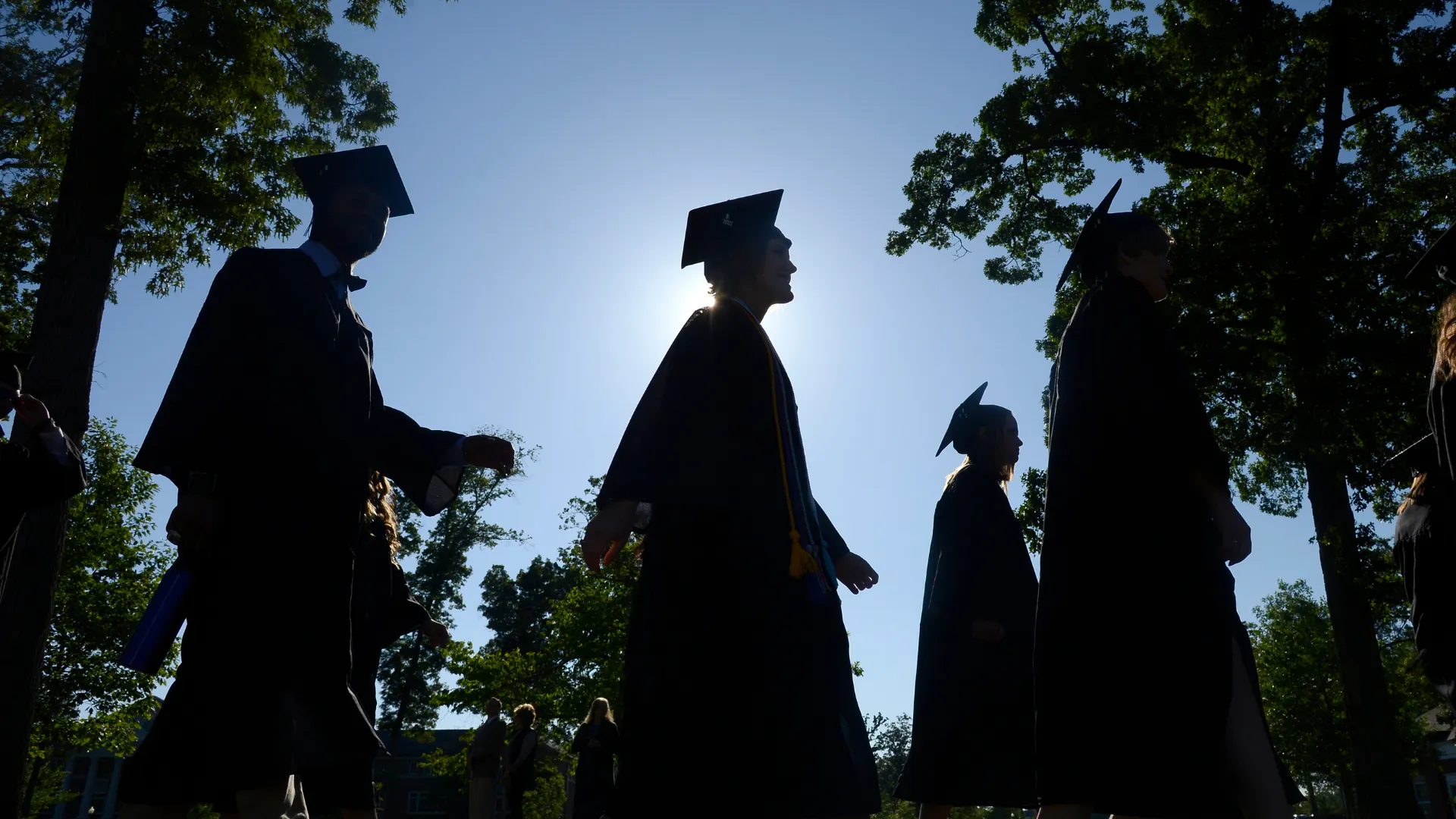 a group of people wearing graduation gowns and caps