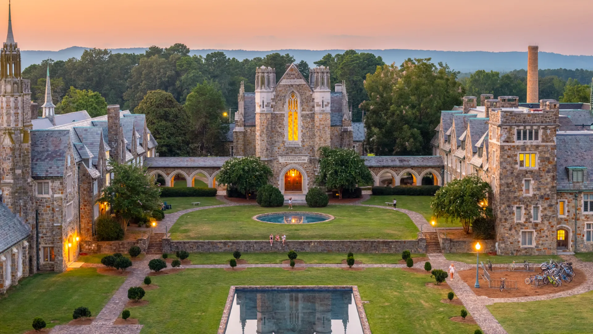 a courtyard with a fountain and buildings in the background