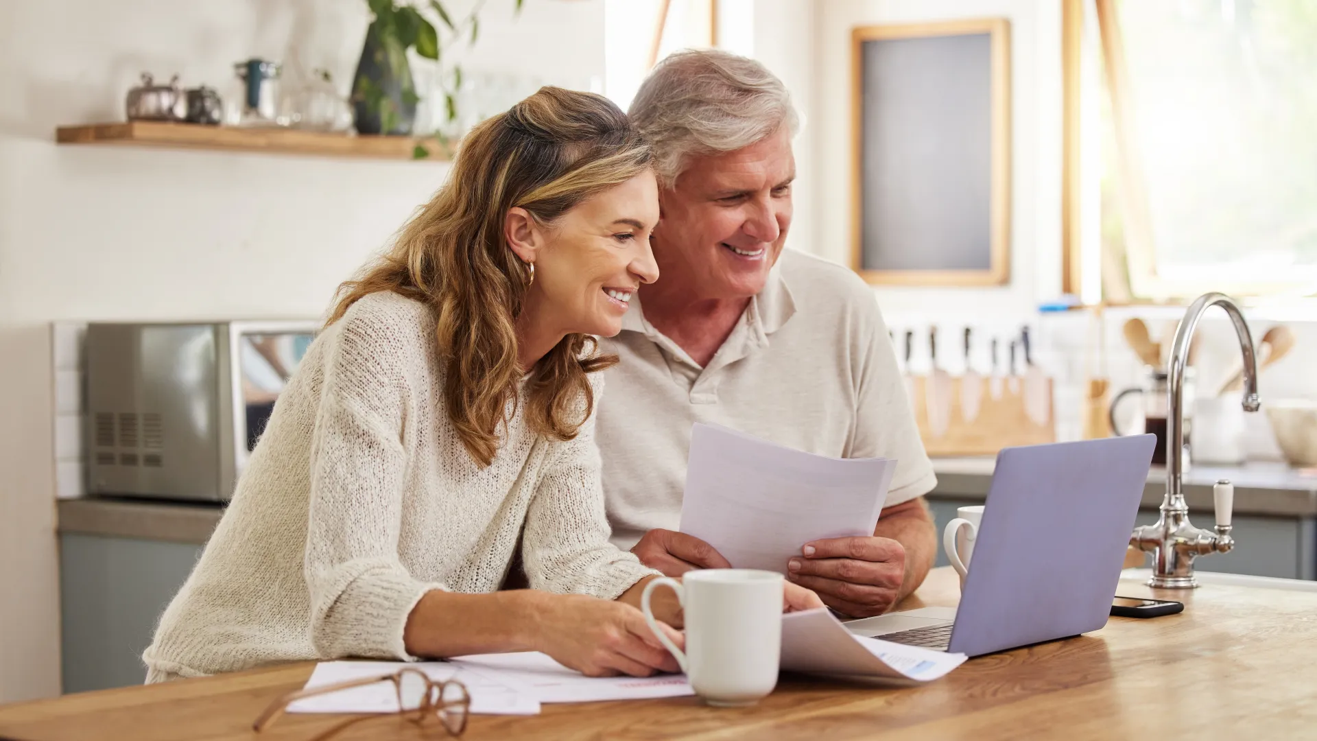 a man and a woman looking at a laptop