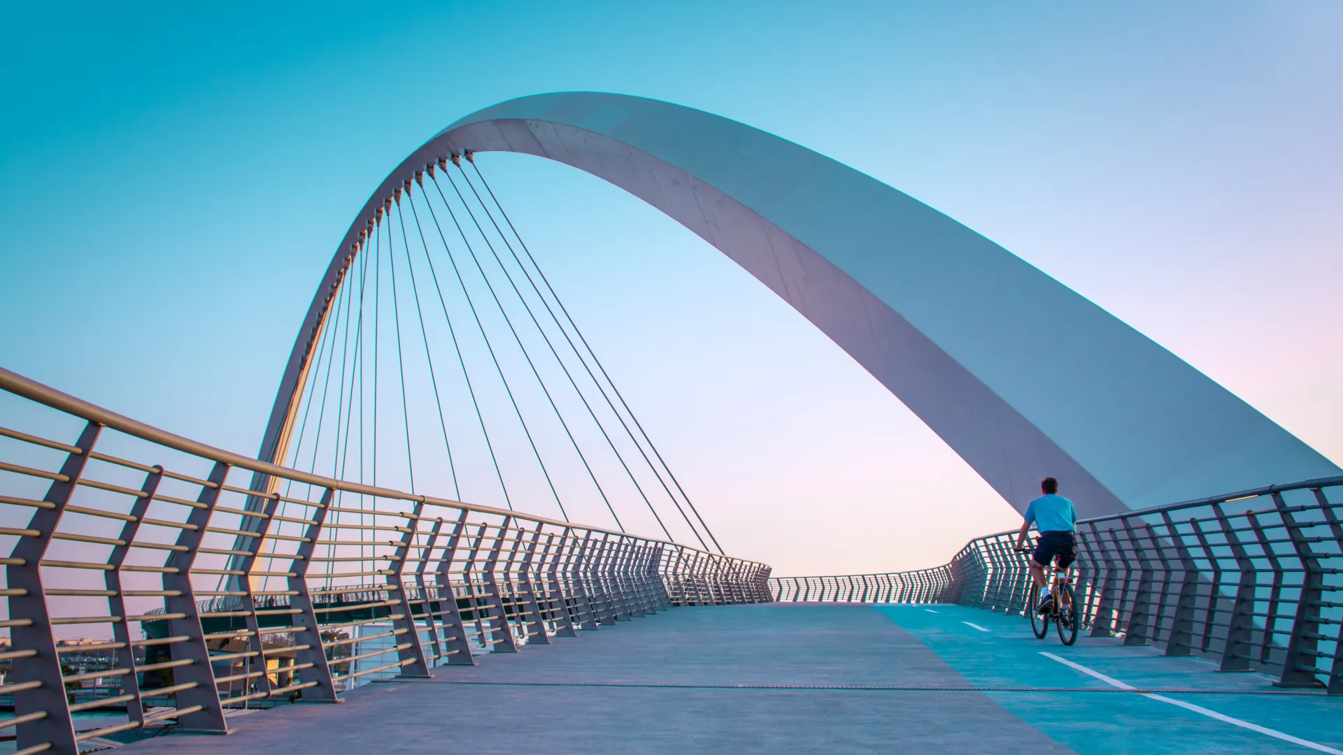 a person riding a bicycle on a bridge