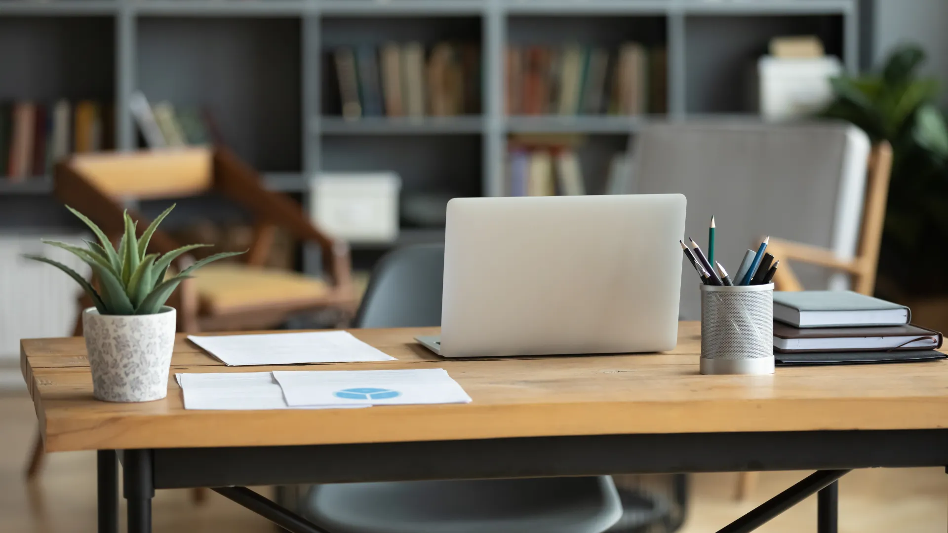 Lawyer and client consulting in office with gavel and scales of justice on desk near laptop