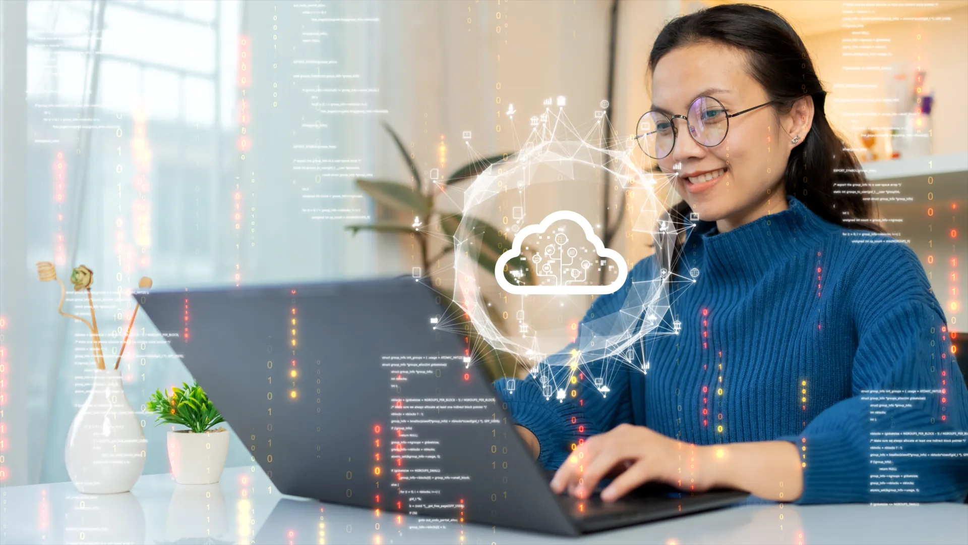 Smiling woman using laptop with cloud computing and digital data icons overlay in bright modern office.