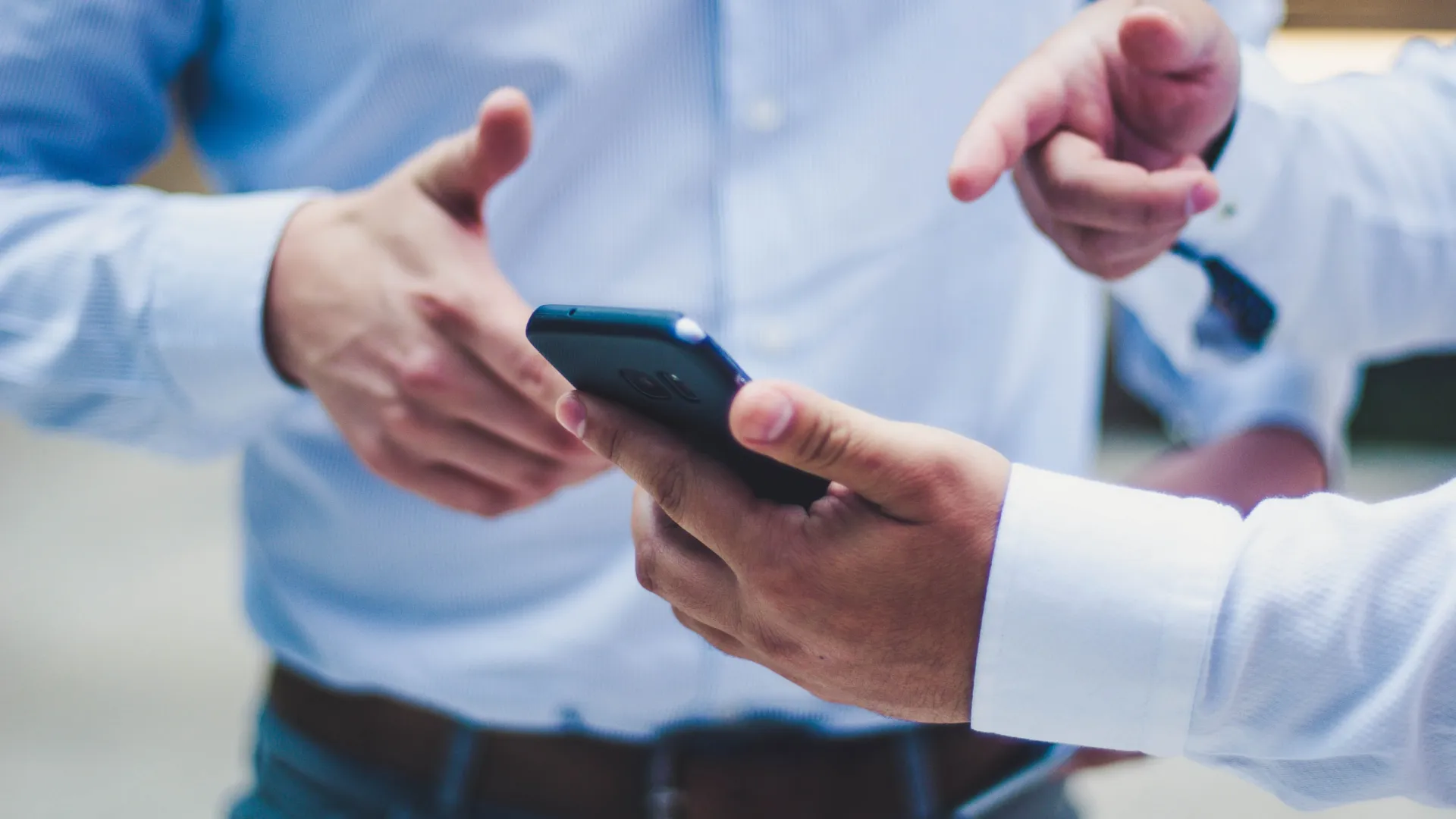 a hand holding a smart phone