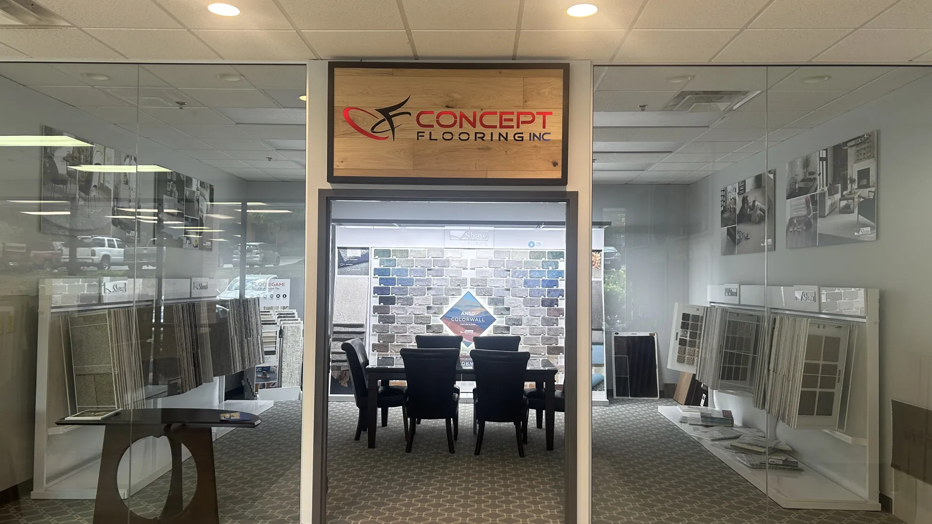 Concept Flooring showroom entrance with tile samples and a seating area for consultations inside