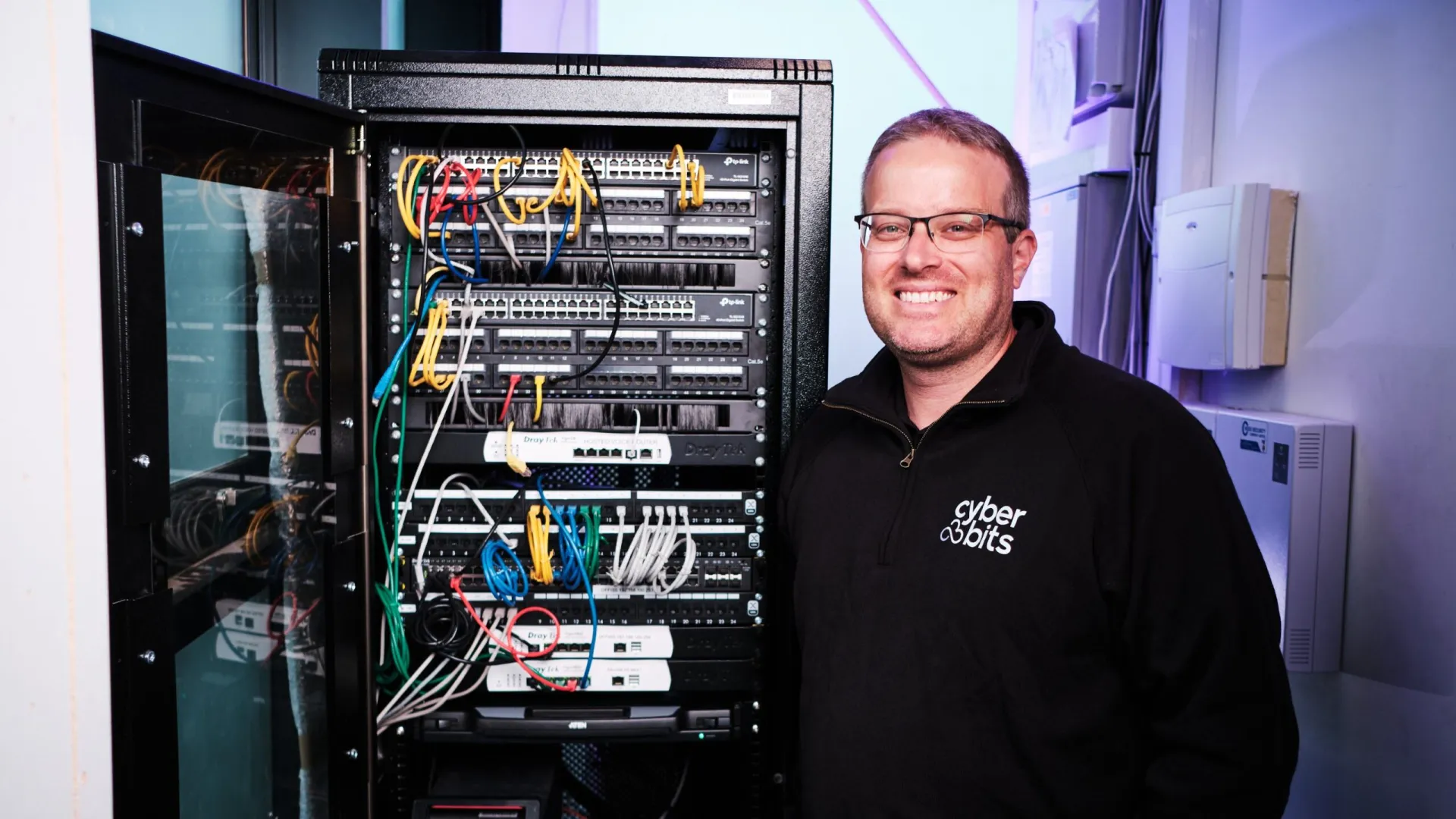 a man standing next to a computer