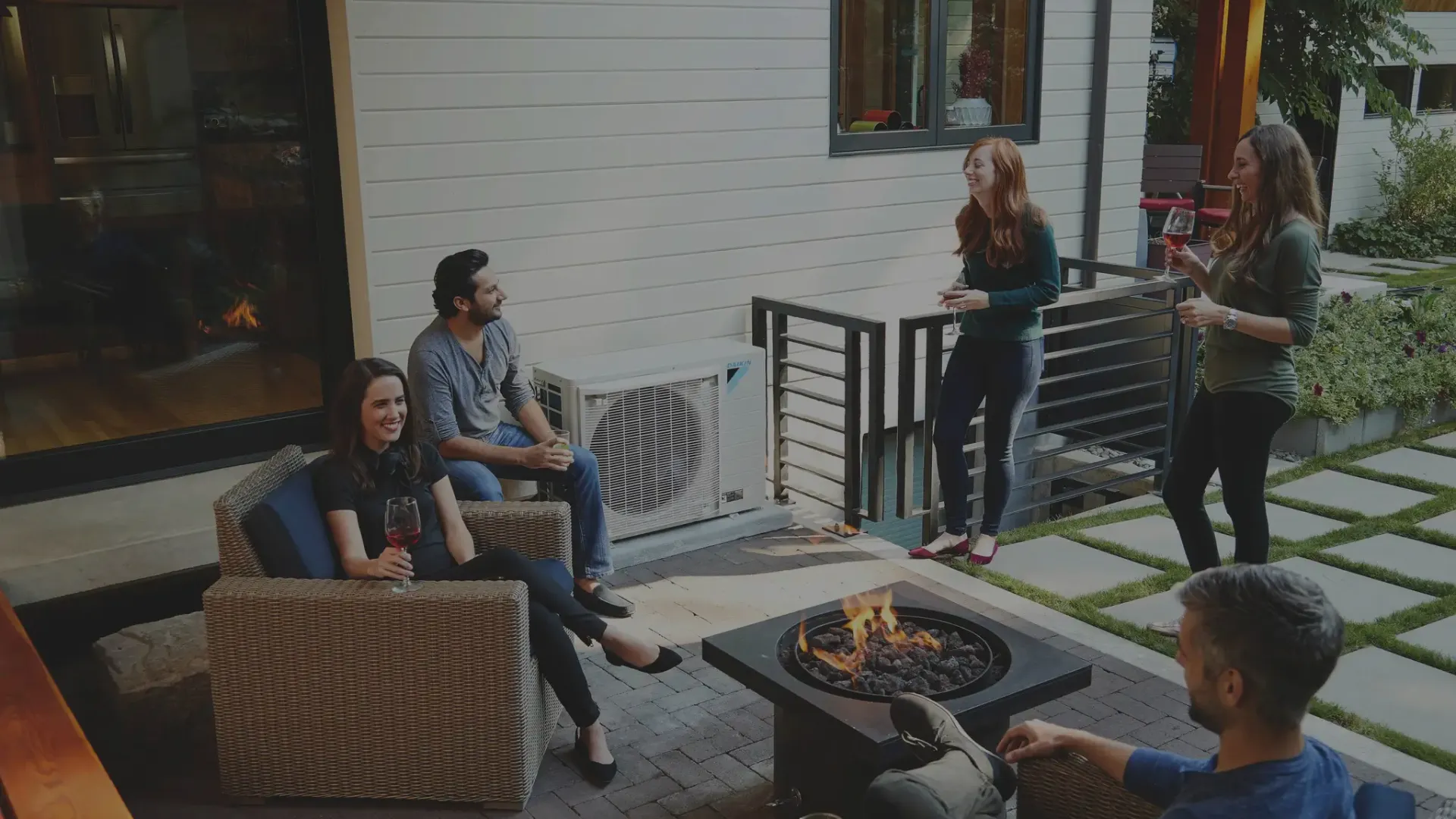 a group of people around a fire pit