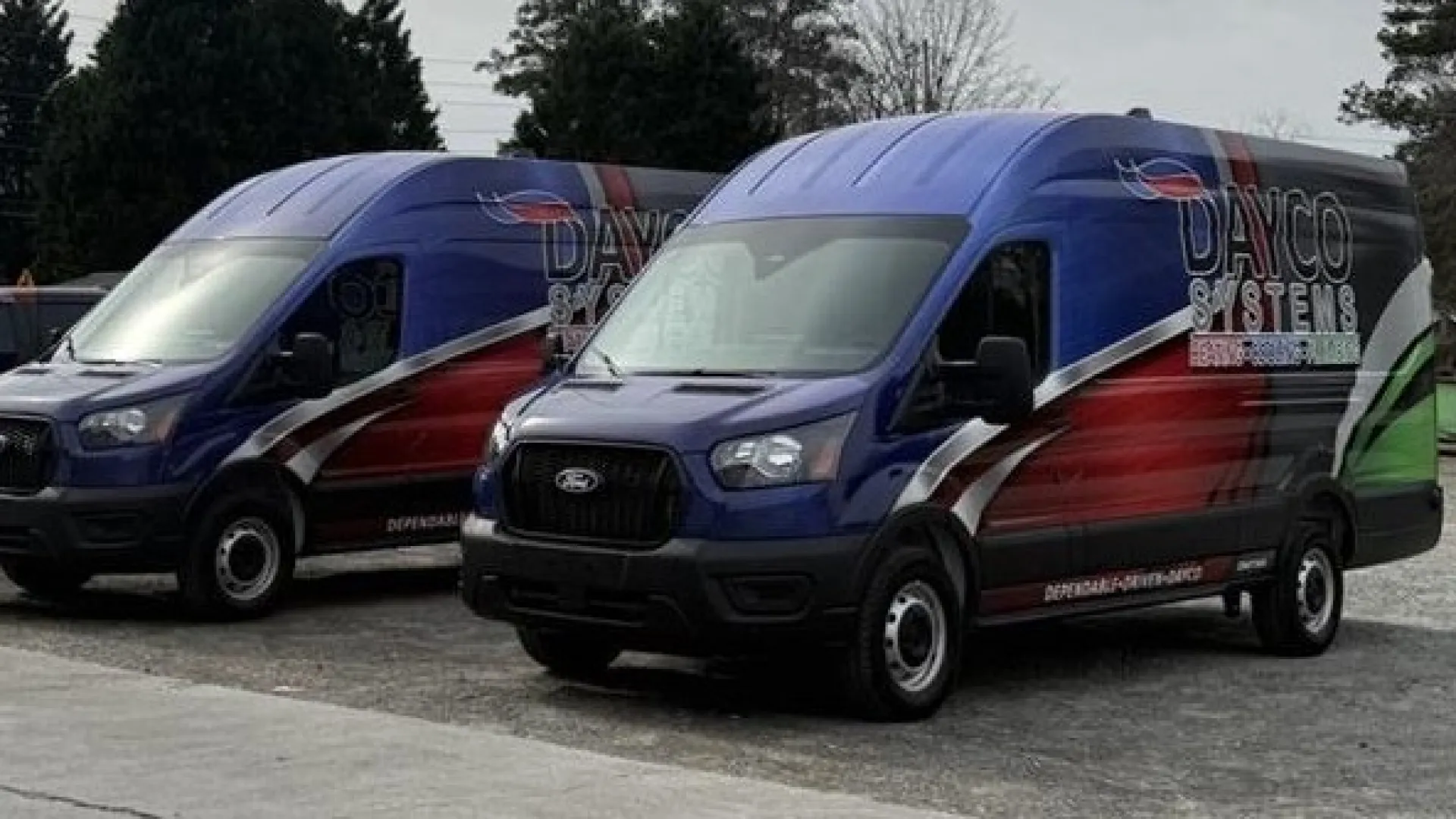 People of Rome Georgia smiling and cutting a ribbon at a Dayco Systems store opening event outdoors.