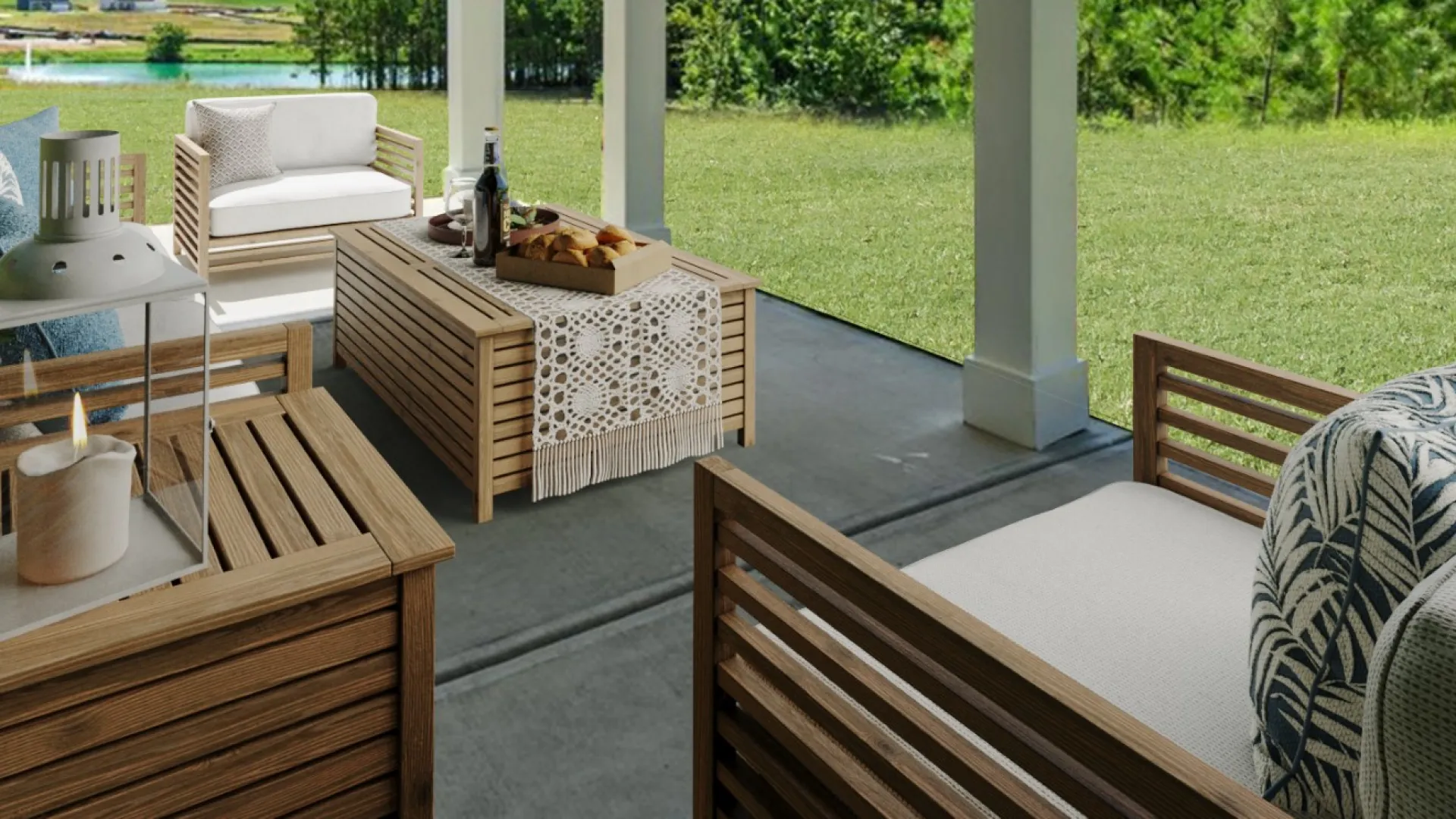 Covered patio with wooden furniture and ceiling fan overlooking a green backyard with trees and blue sky.
