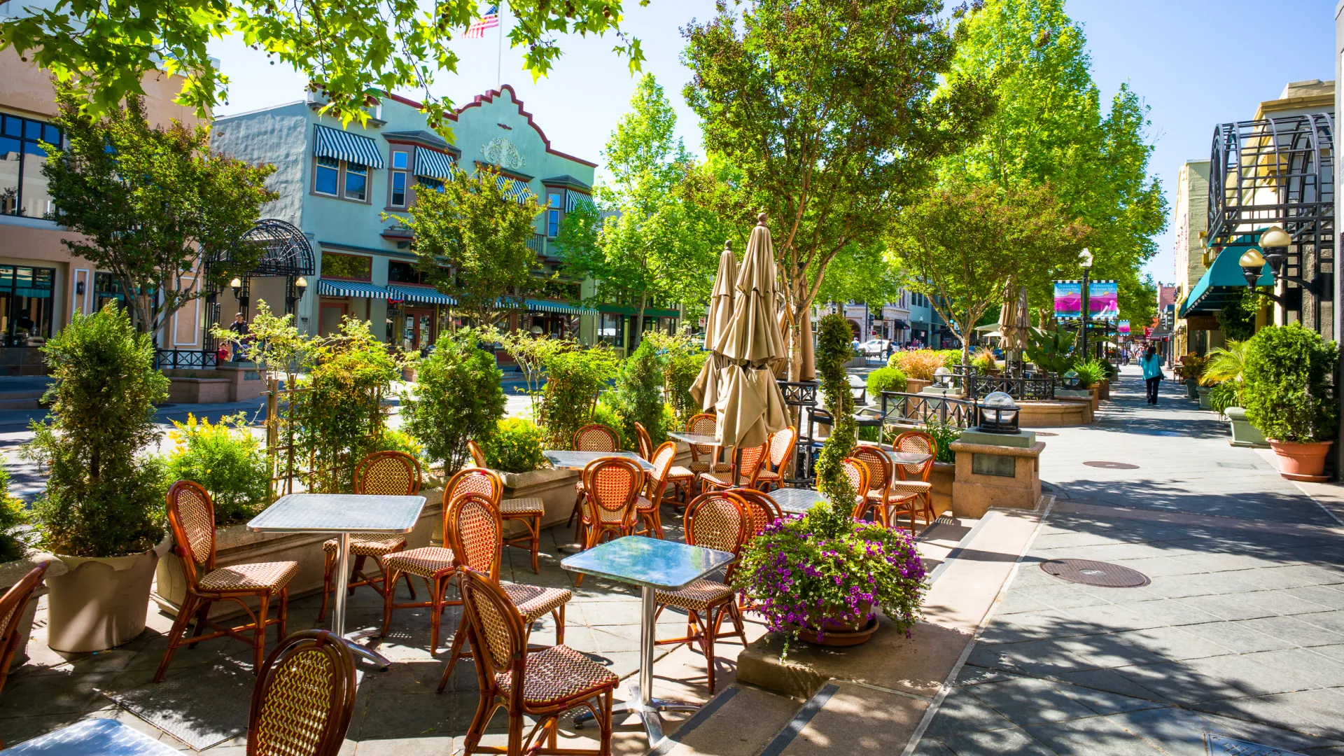 a courtyard with tables and chairs