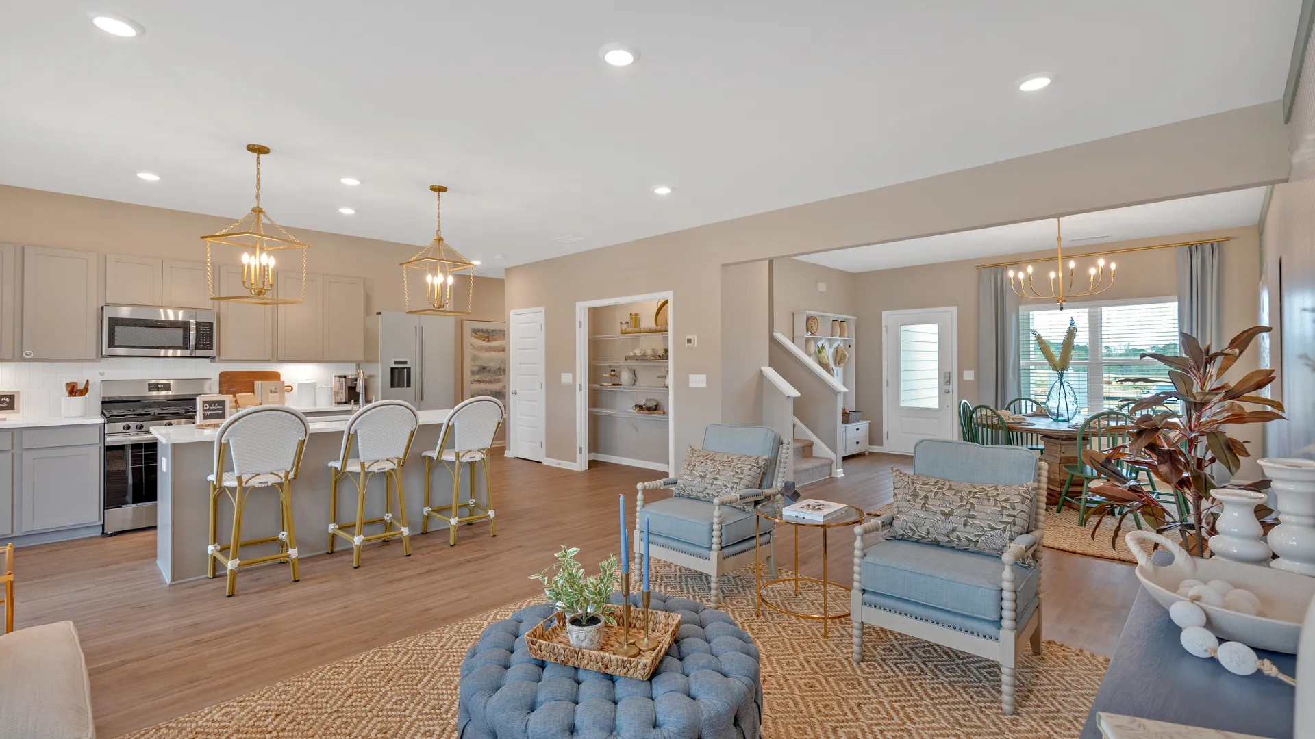 Modern open-concept living area showcasing stylish furniture and bright natural lighting.