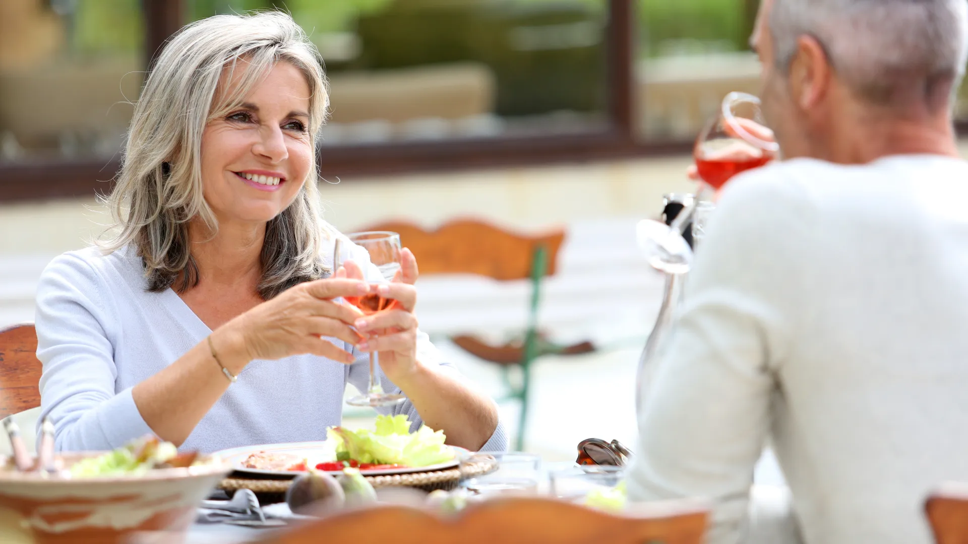 a man and a woman sitting at a table with food