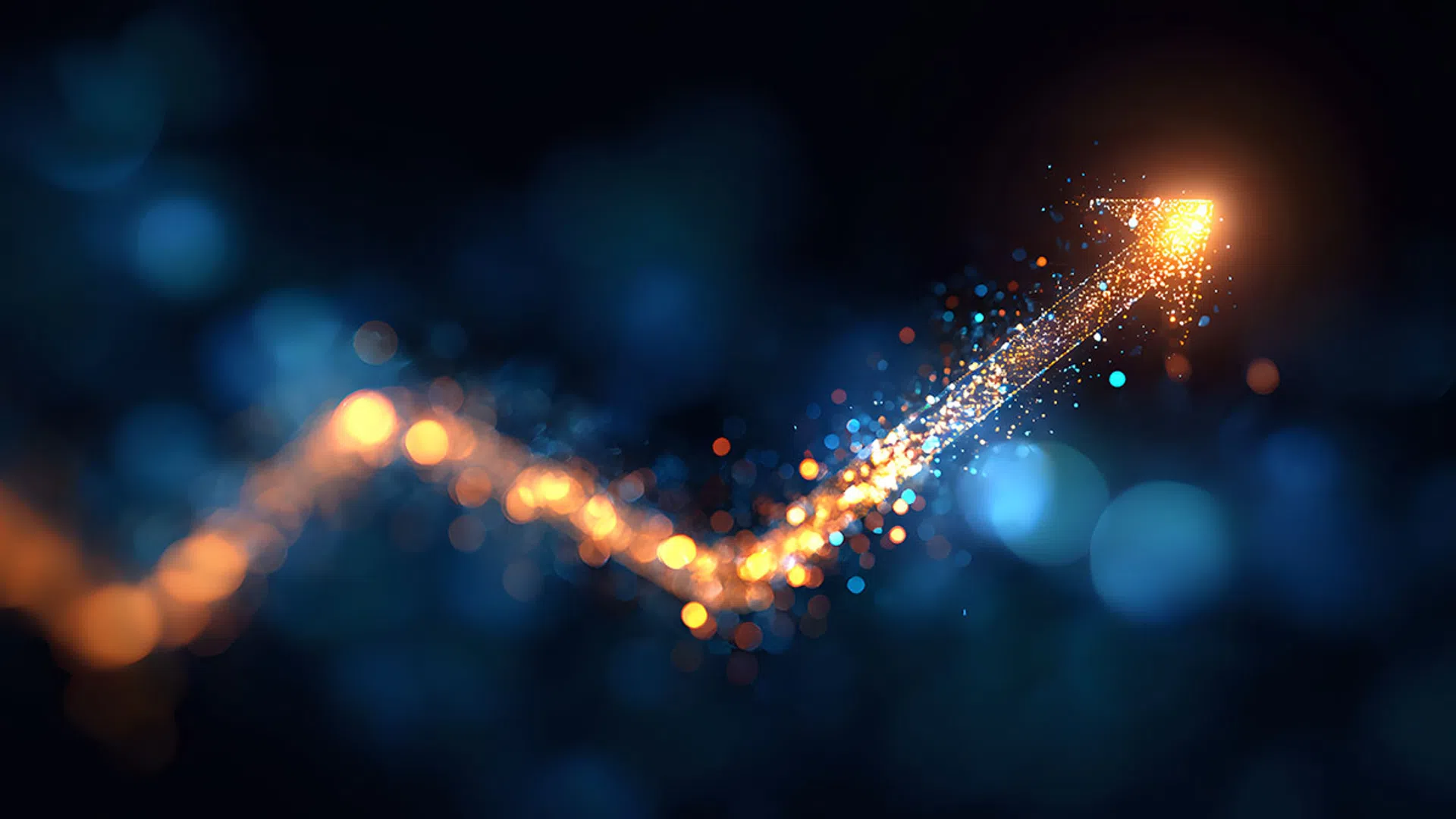 Glowing upward arrow made of bright orange and blue particles on a dark blurred background symbolizing growth.