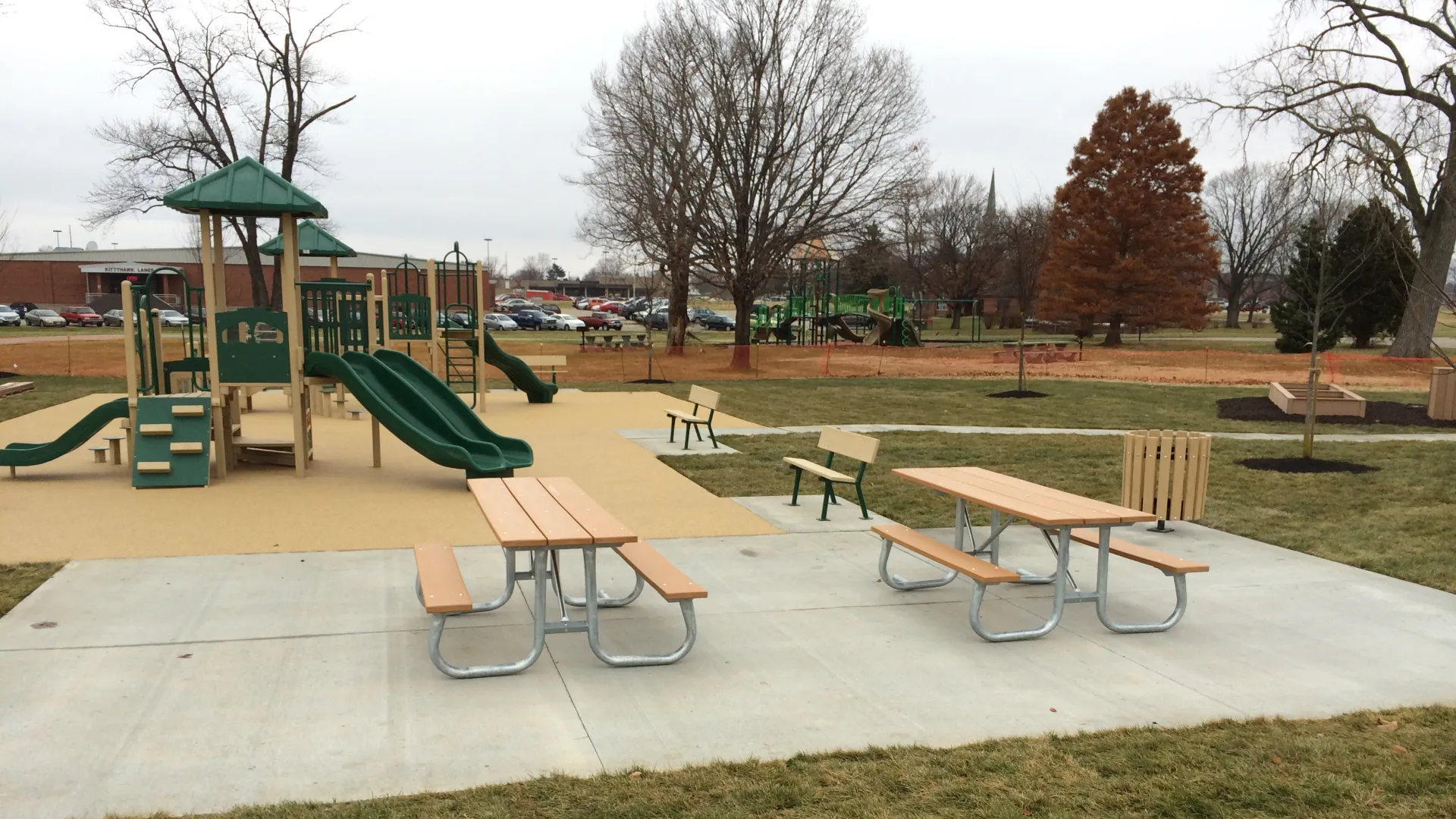 a playground with a slide and tables