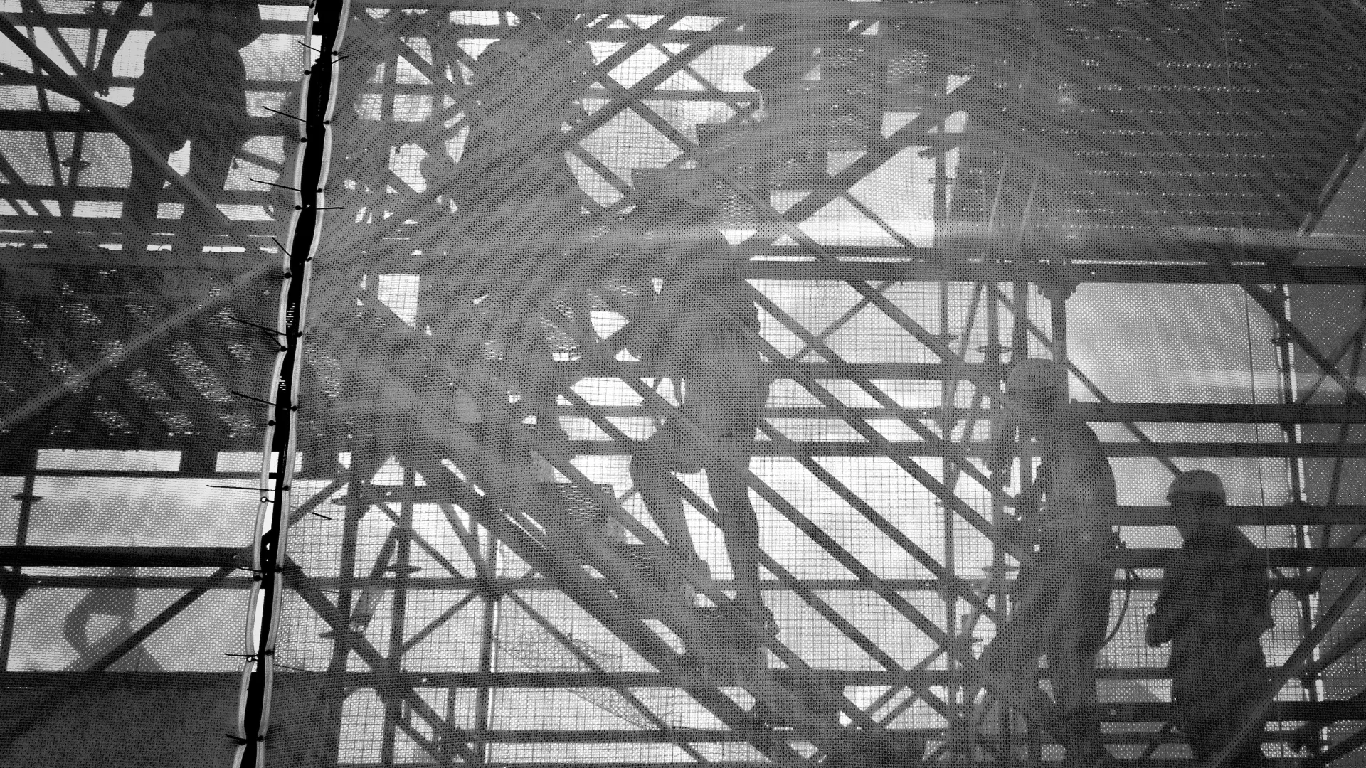 a group of men working on a large metal structure