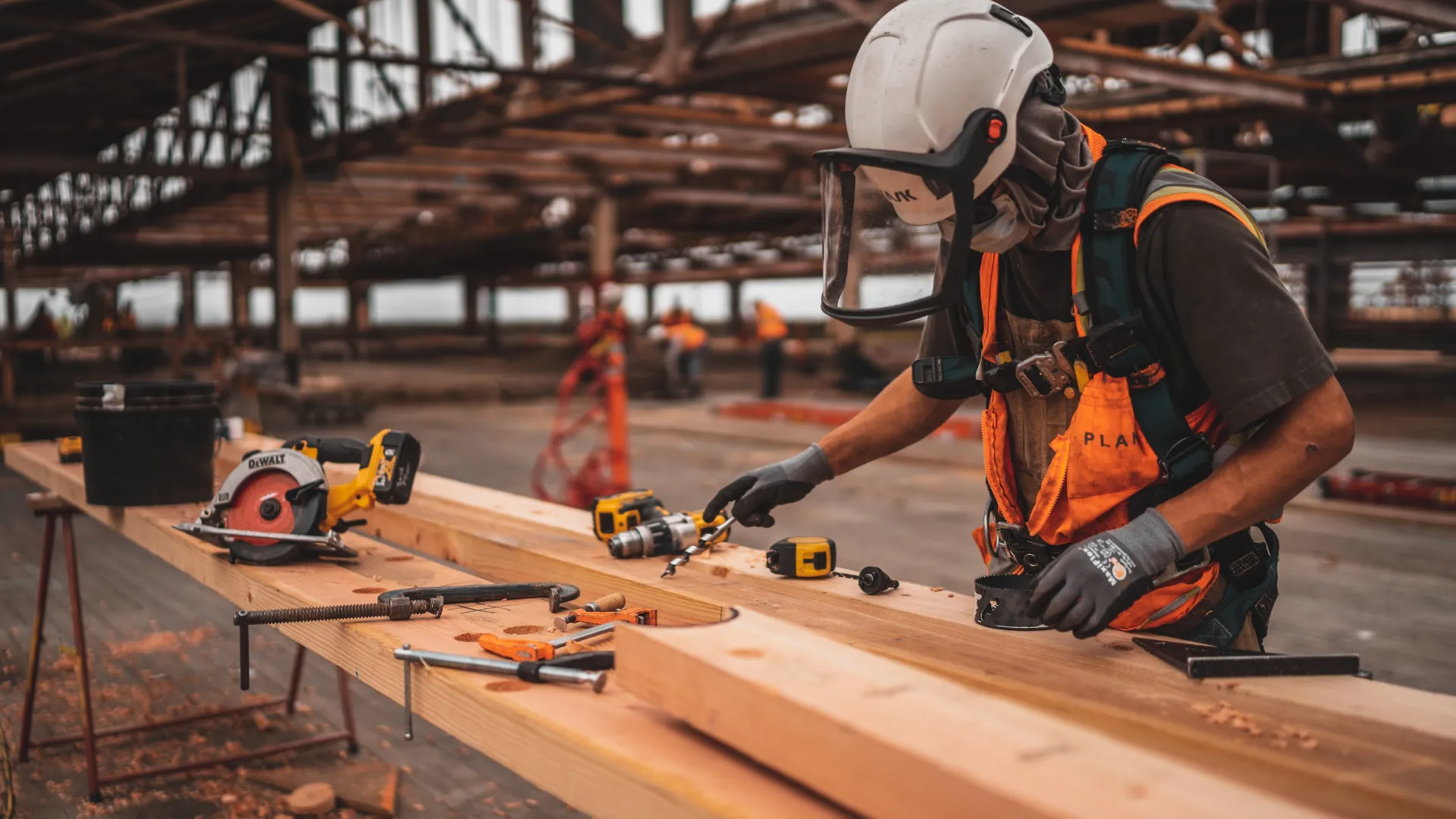 a person wearing a helmet and working on a piece of wood