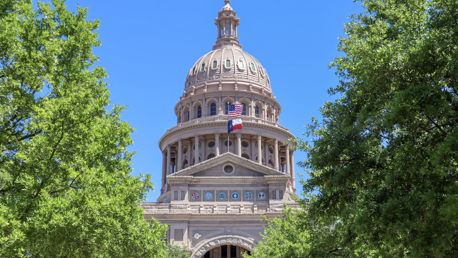 Texas State Capitol with a dome and a flag on top