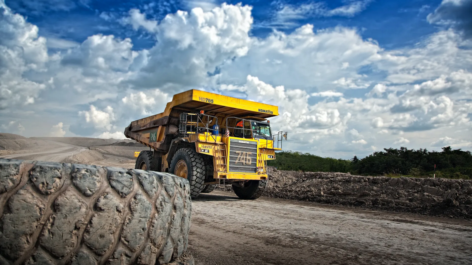 a yellow truck in a field