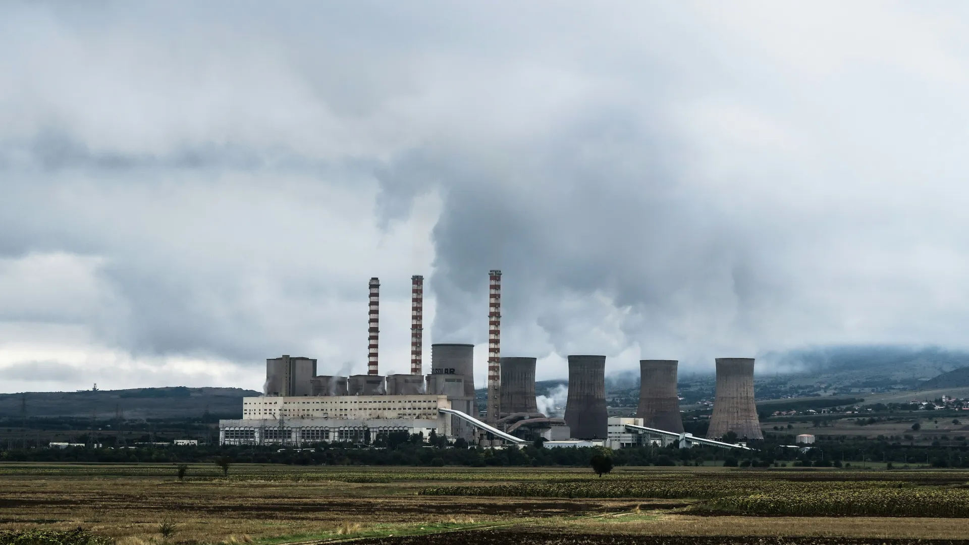 a factory with smoke stacks