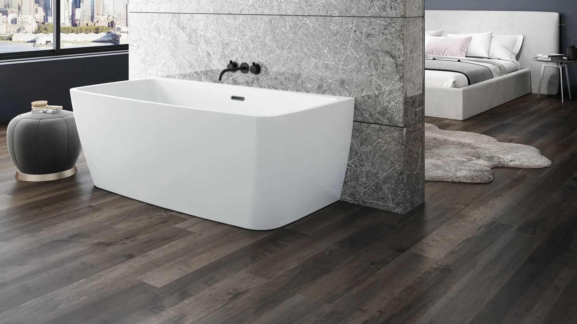 Modern bathroom with freestanding white bathtub, gray marble wall, city view window, and adjacent bedroom area.