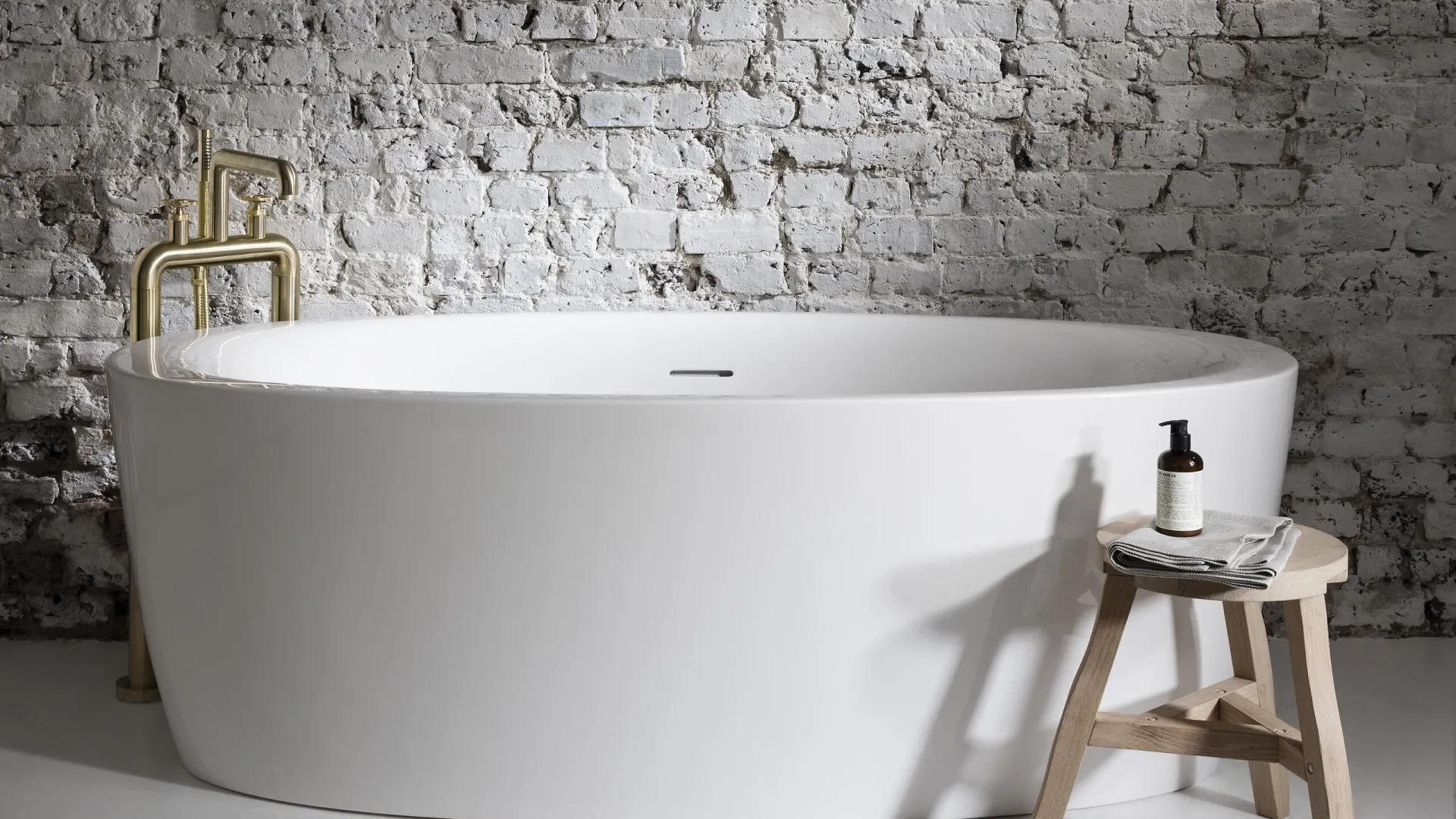 a white bathtub with a stool