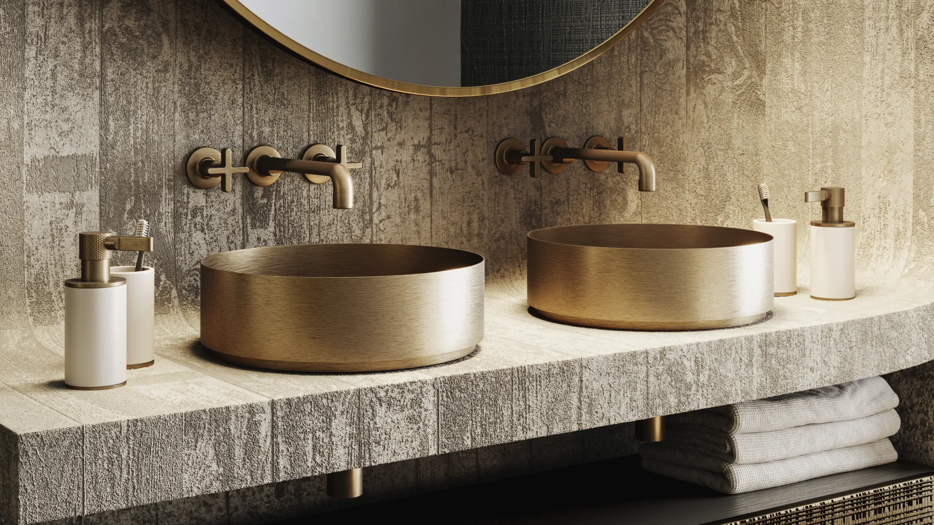 Modern bathroom with twin gold sinks, circular mirror, gold fixtures, and beige textured countertop and wall.