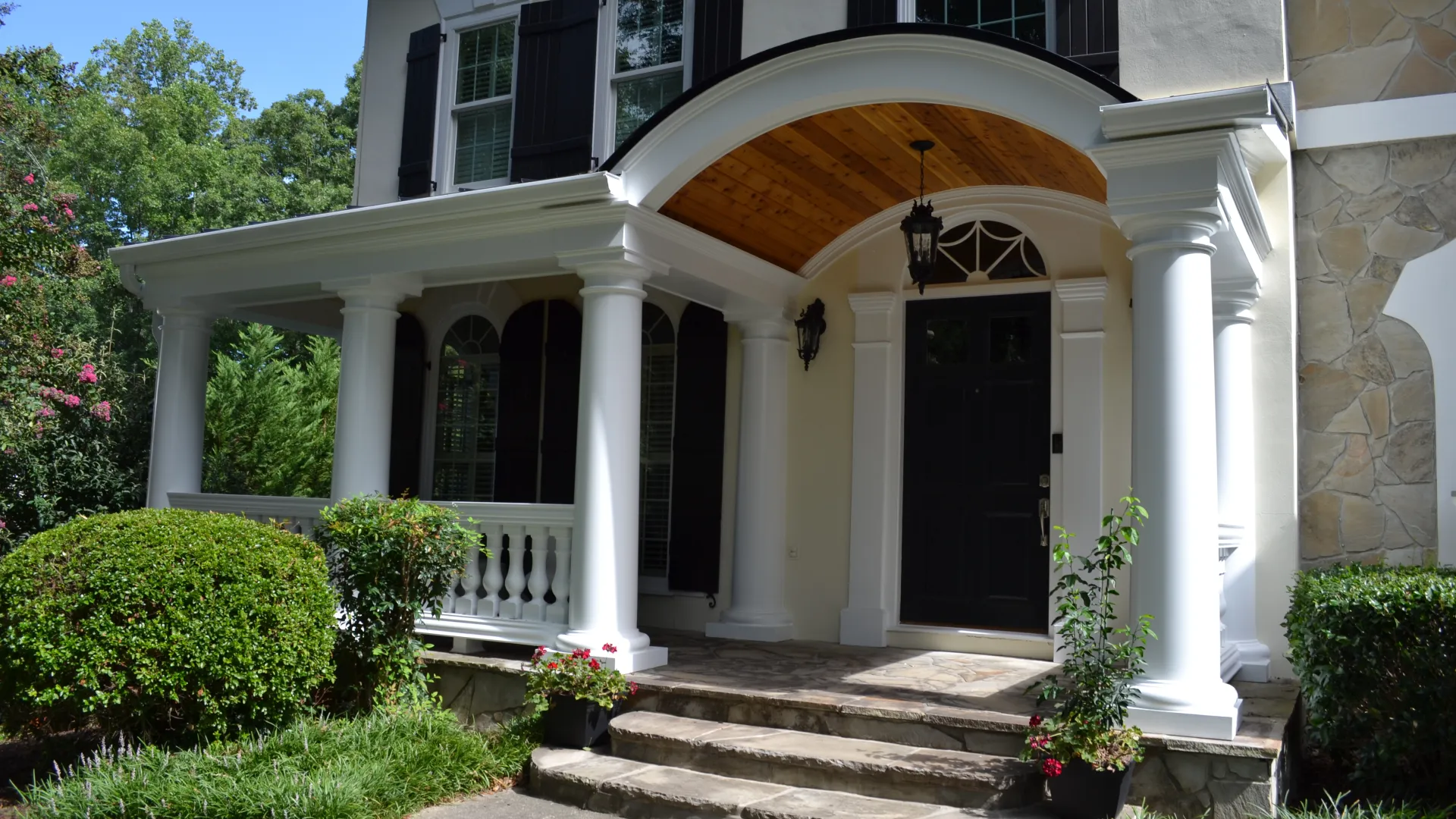 a white house with pillars and a door