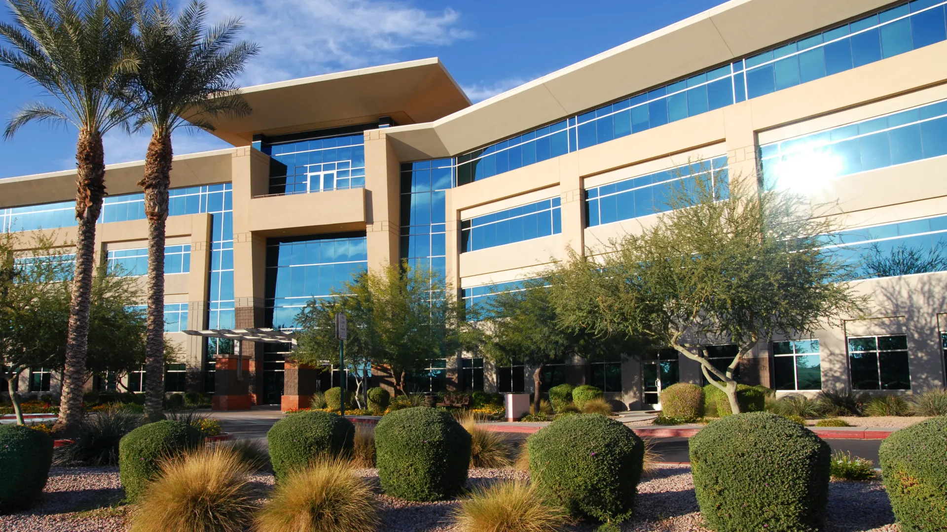 a building with trees and bushes in front of it