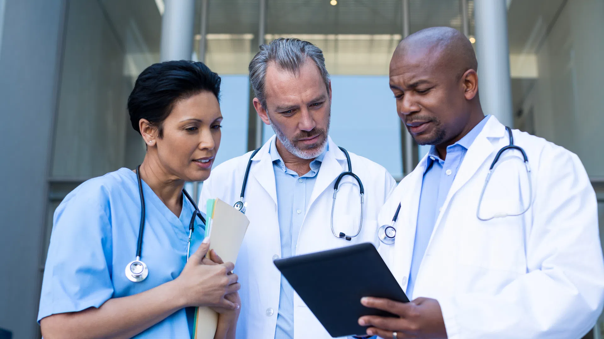 a few doctors looking at a tablet