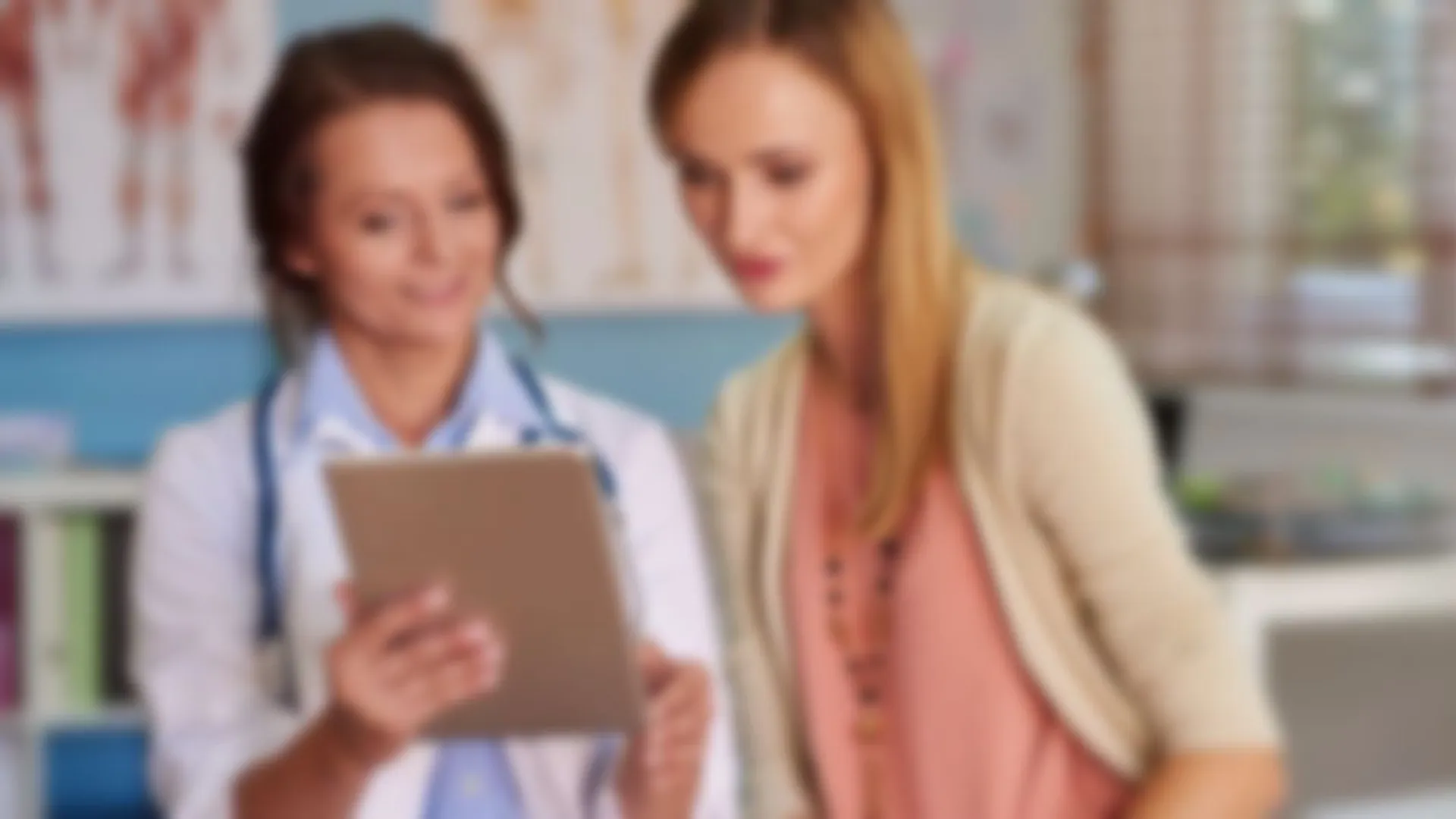 a few women looking at a tablet
