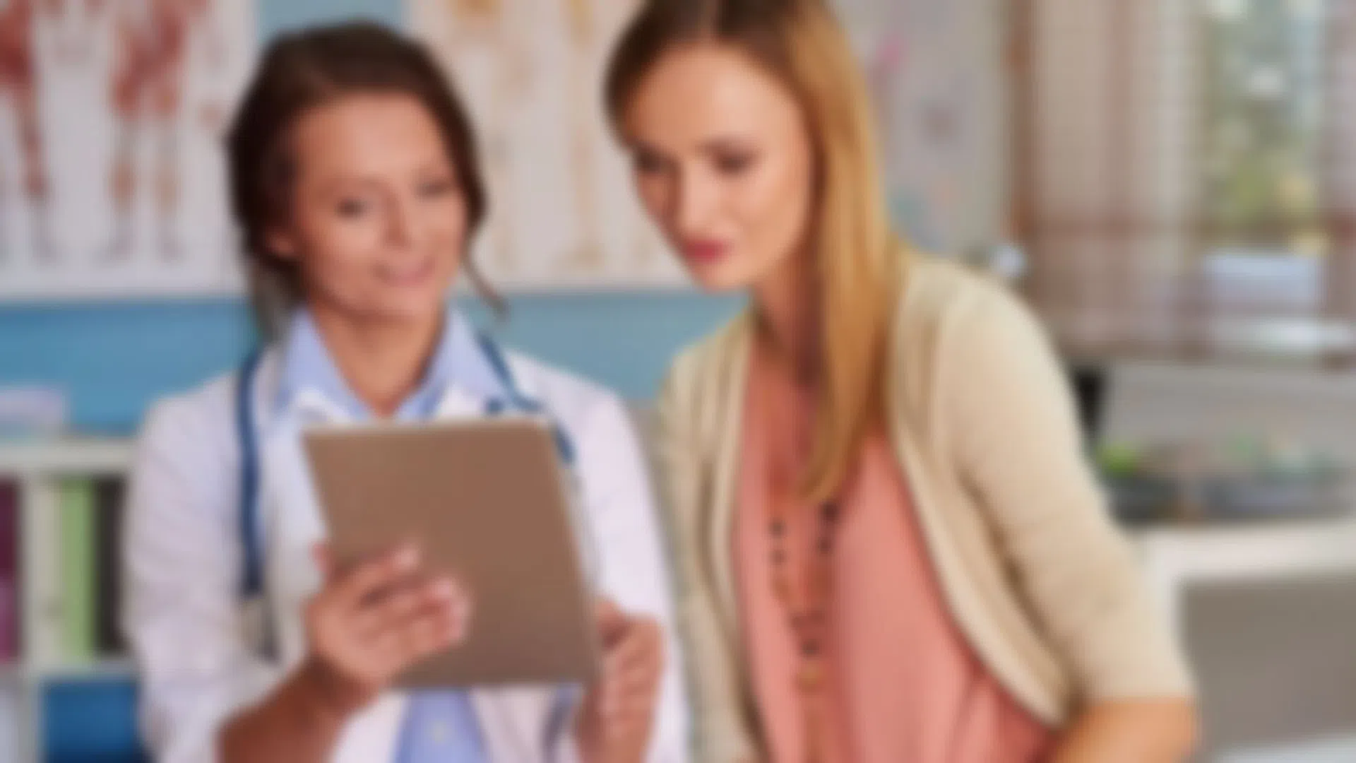a few women looking at a tablet