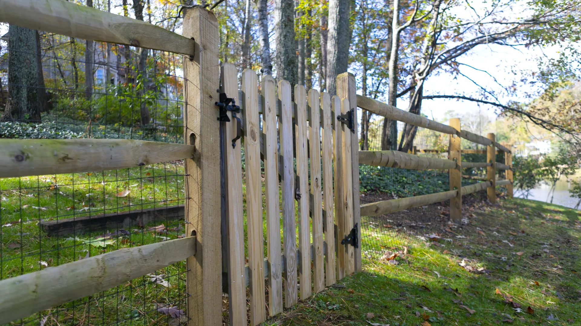 a wooden fence in a wooded area