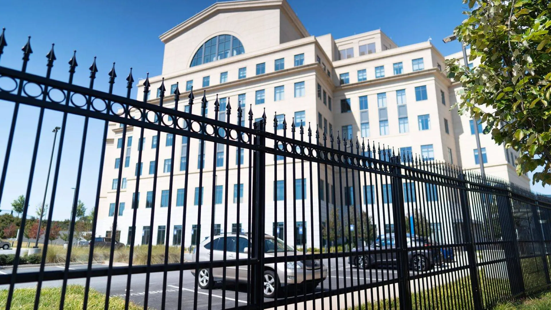 a black fence in front of a building