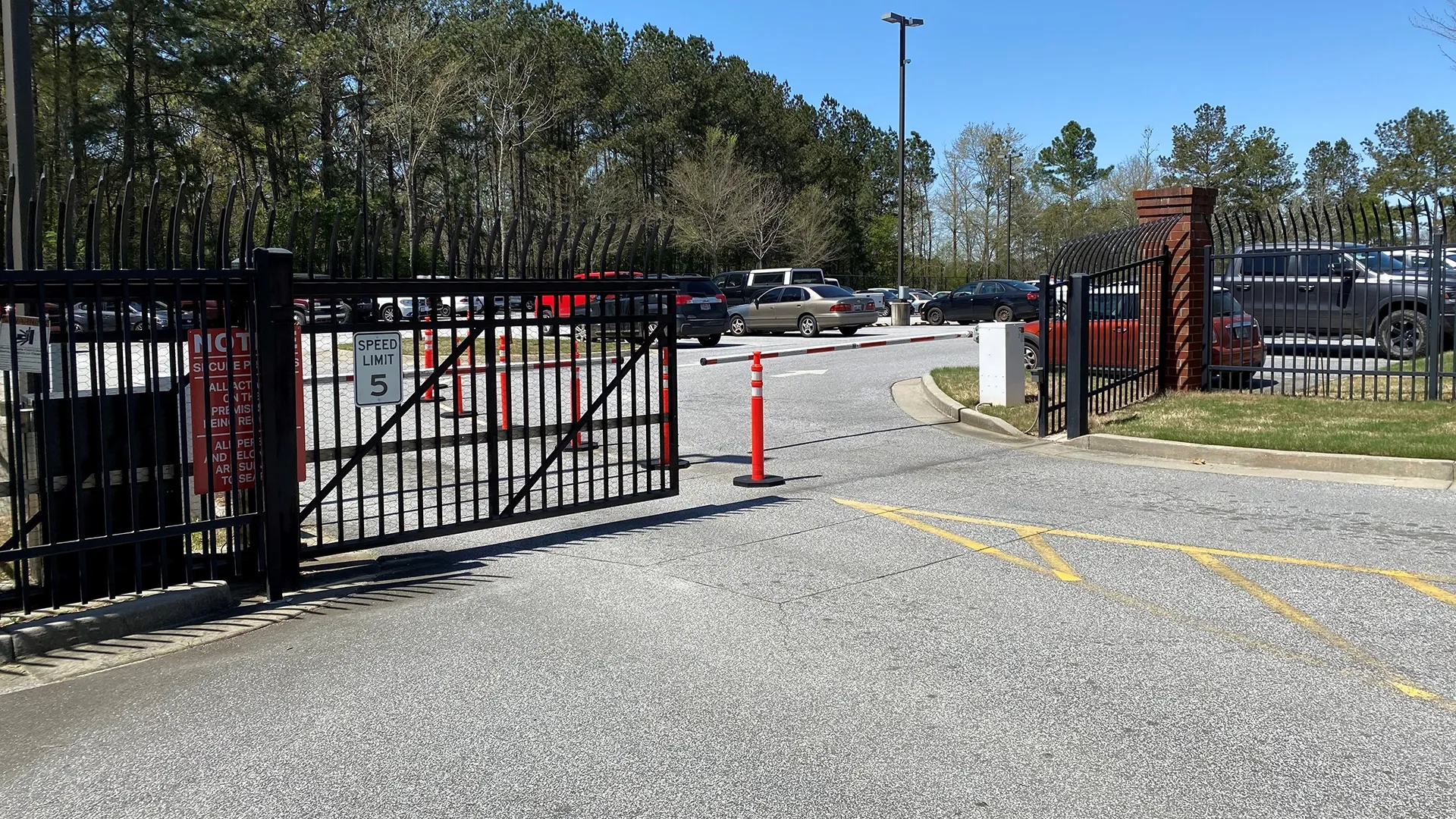 a road with a gate and cars on it