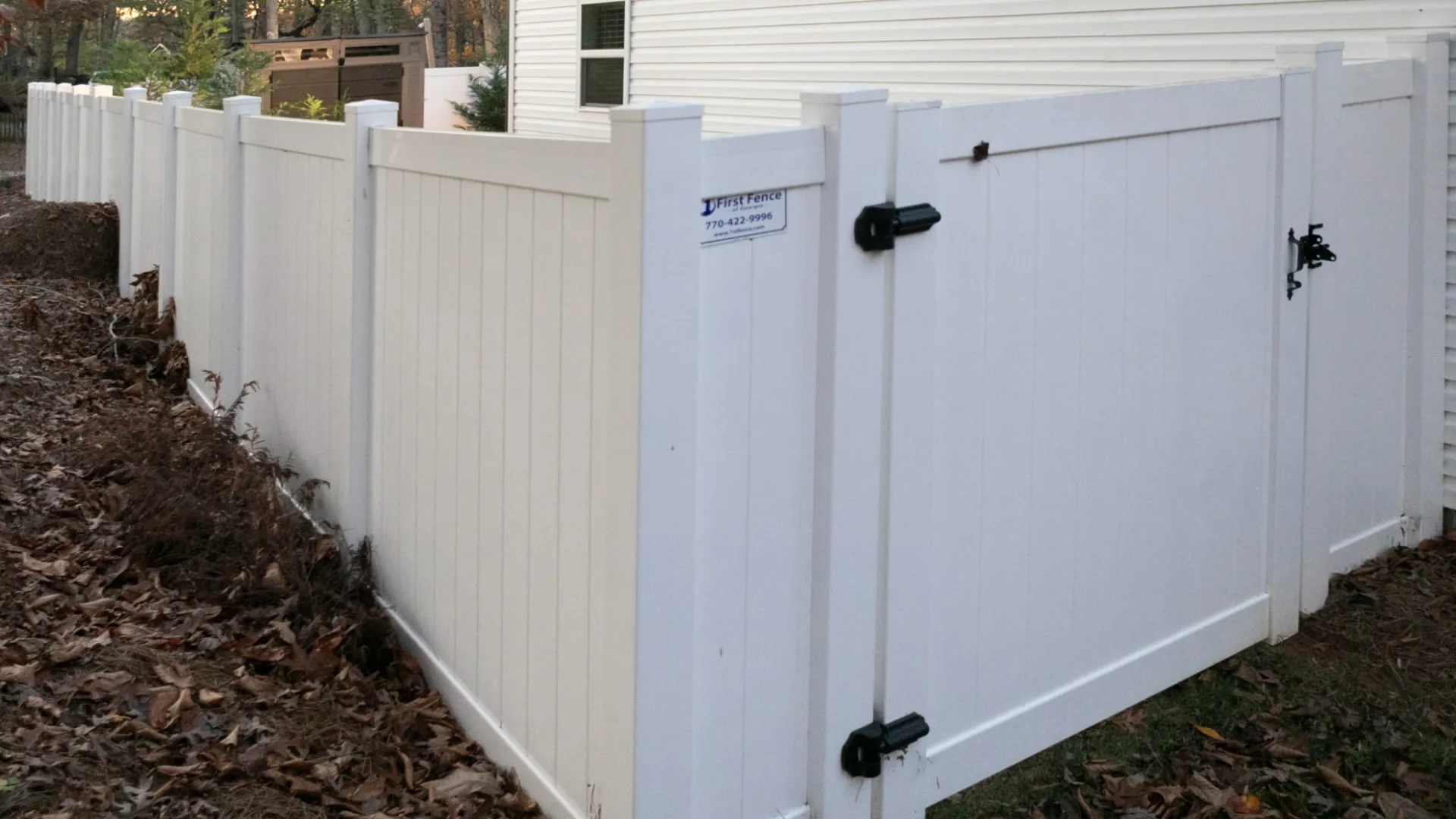 a white shed with a black door