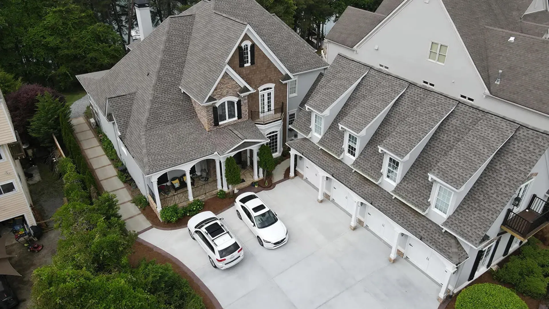 a street with cars parked on it and houses around it