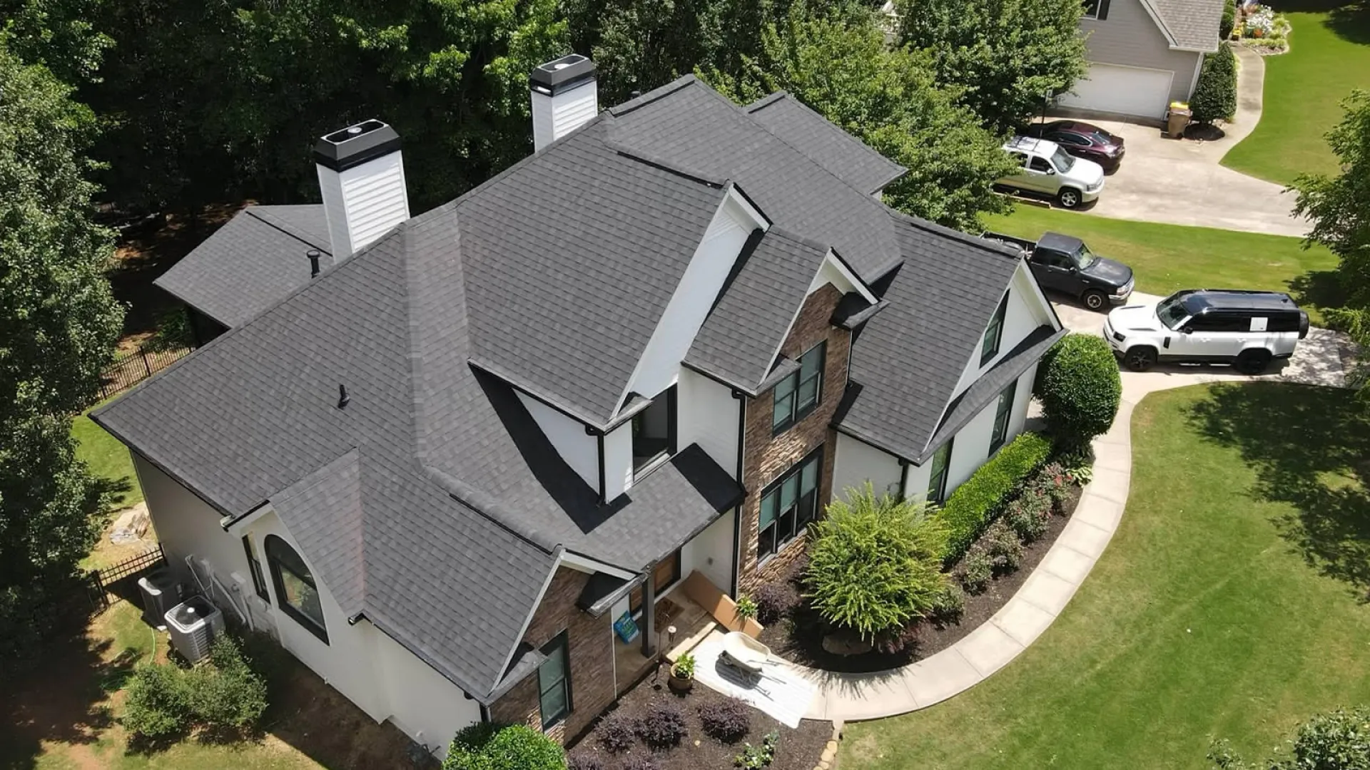 a house with a driveway and cars parked in the driveway