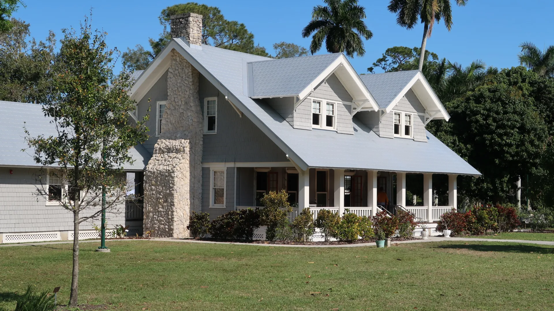 a large white house with trees and grass in front of it