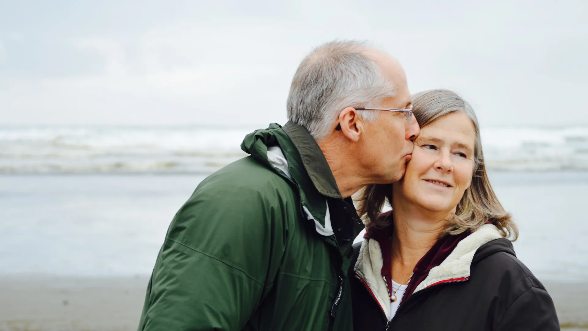 a man kissing a woman on the cheek