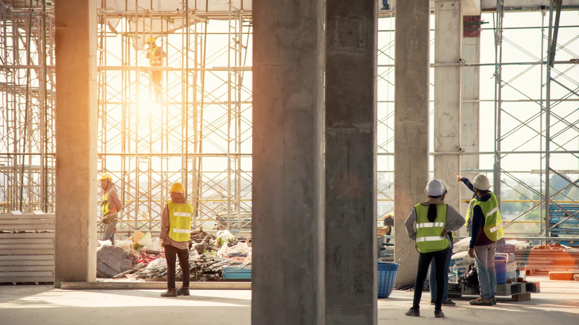 construction site with concrete columns and contractors